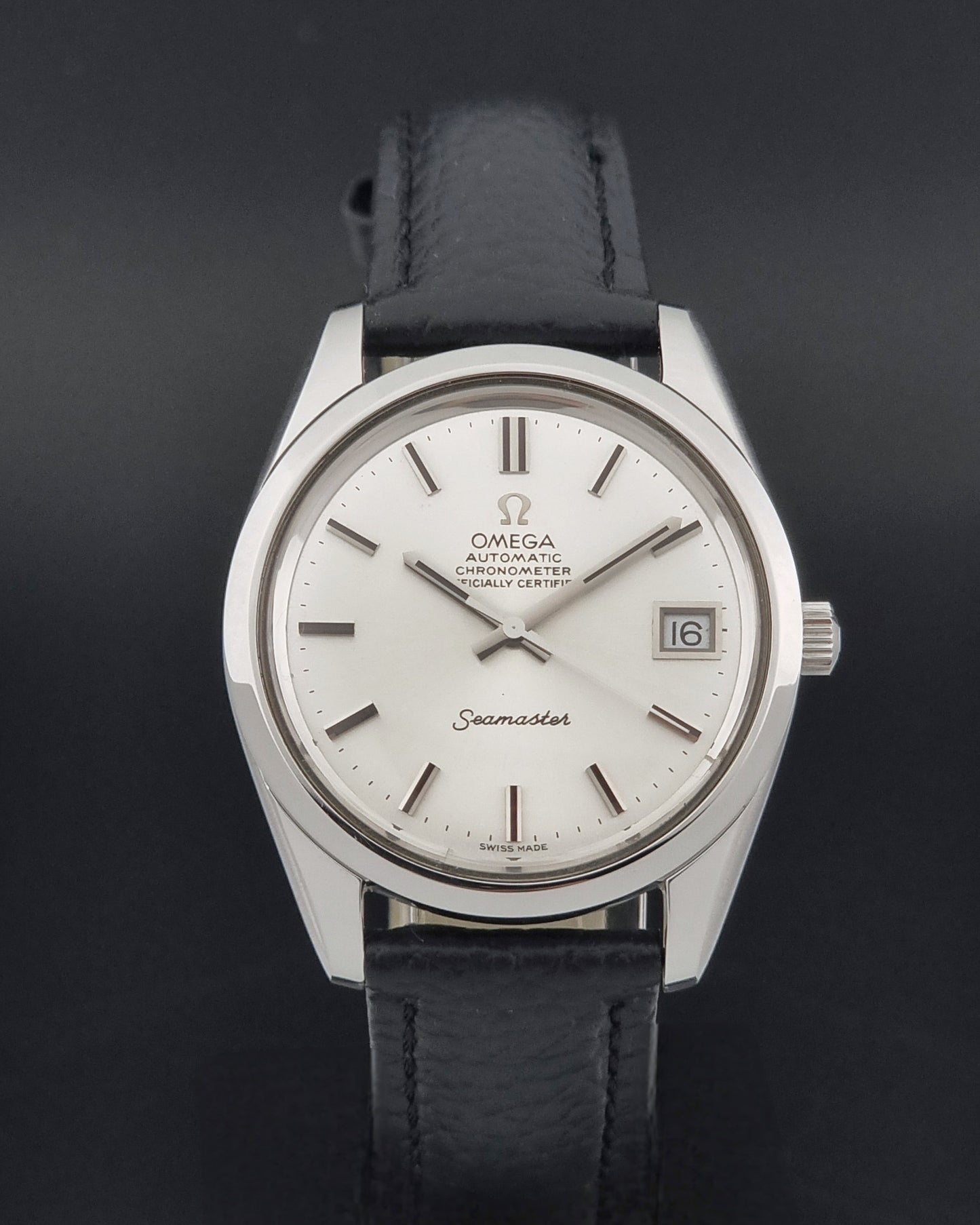 Vintage Omega Seamaster 168.0061/166.0172 with a silver stainless steel case and a textured black leather strap, shown on a dark background close dial view