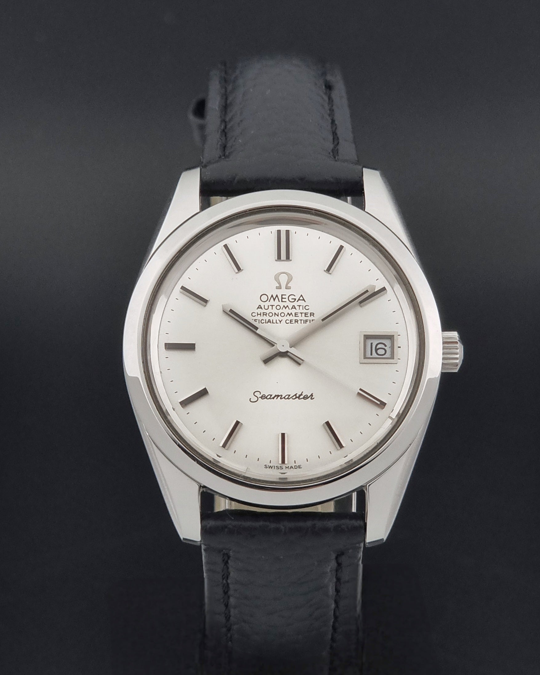 Vintage Omega Seamaster 168.0061/166.0172 with a silver stainless steel case and a textured black leather strap, shown on a dark background close dial view