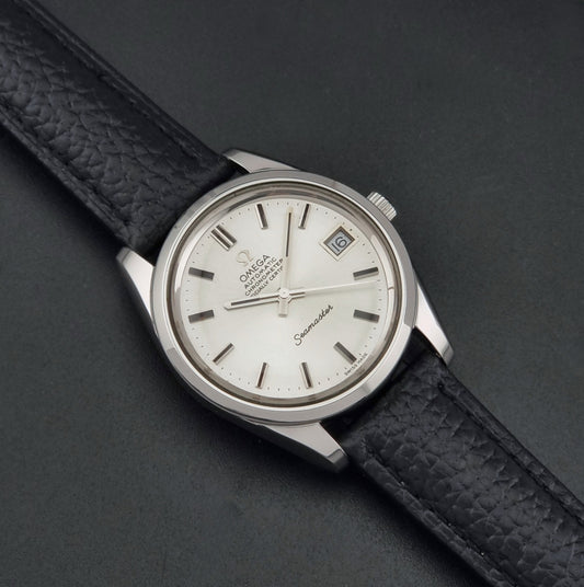 Vintage Omega Seamaster 168.0061/166.0172 with a silver stainless steel case and a textured black leather strap, shown on a dark background dial