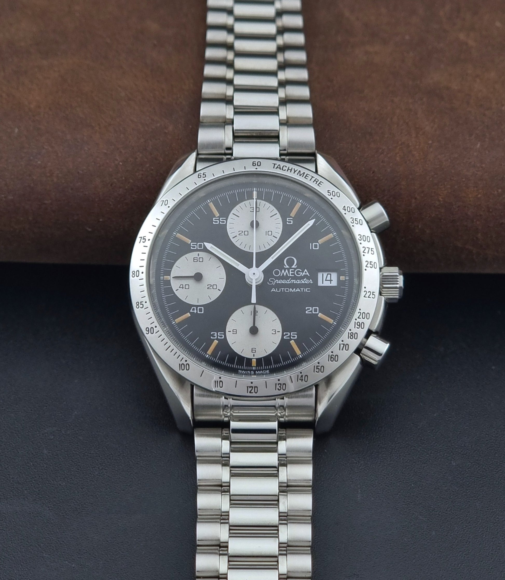 Vintage Omega Speedmaster 3511.50 watch Reverse Panda with a black face on a dark background dial view