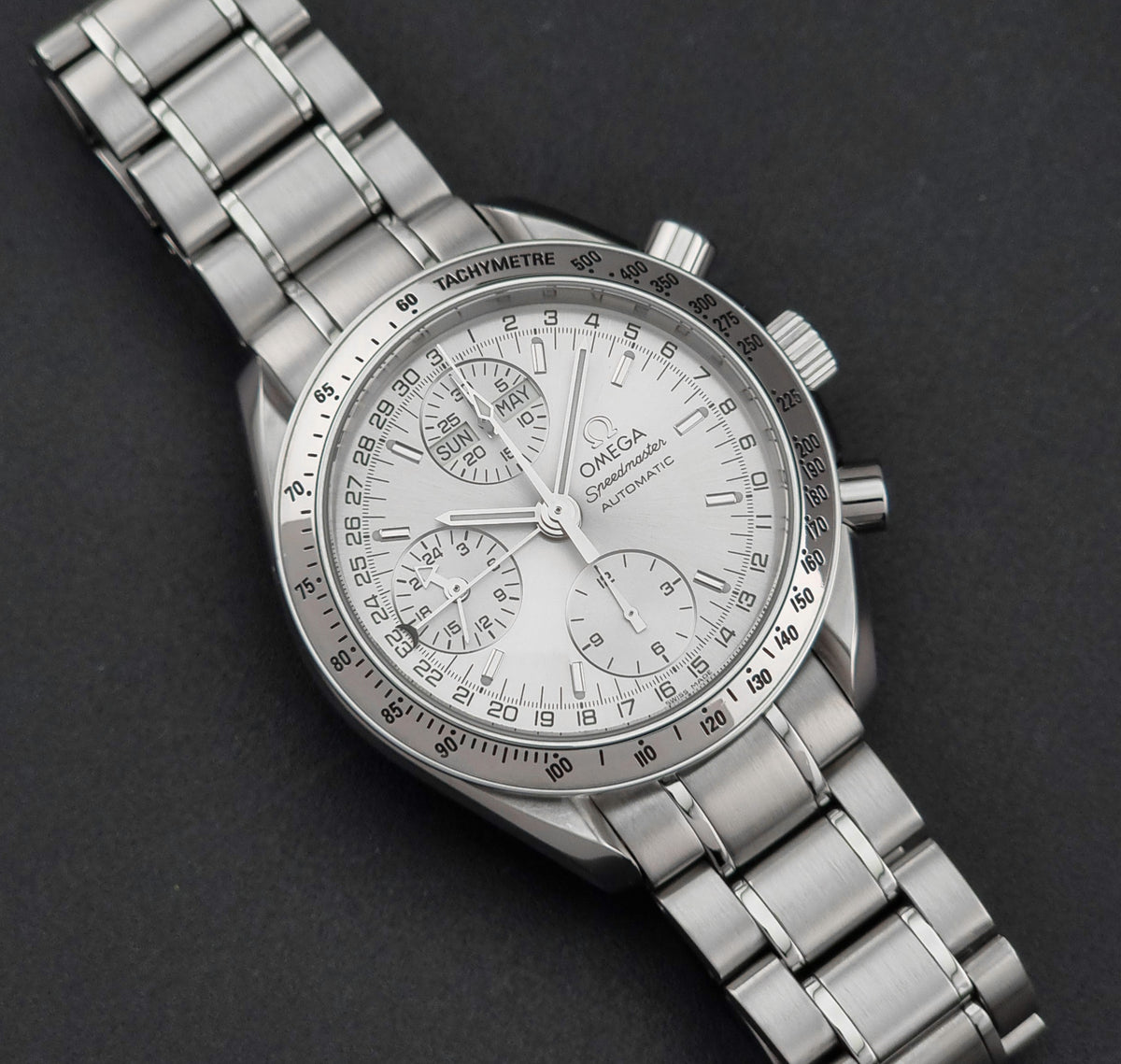 1999 Omega Speedmaster 3523.30 Triple Date automatic chronograph, front view highlighting the silver sunburst chronograph dial