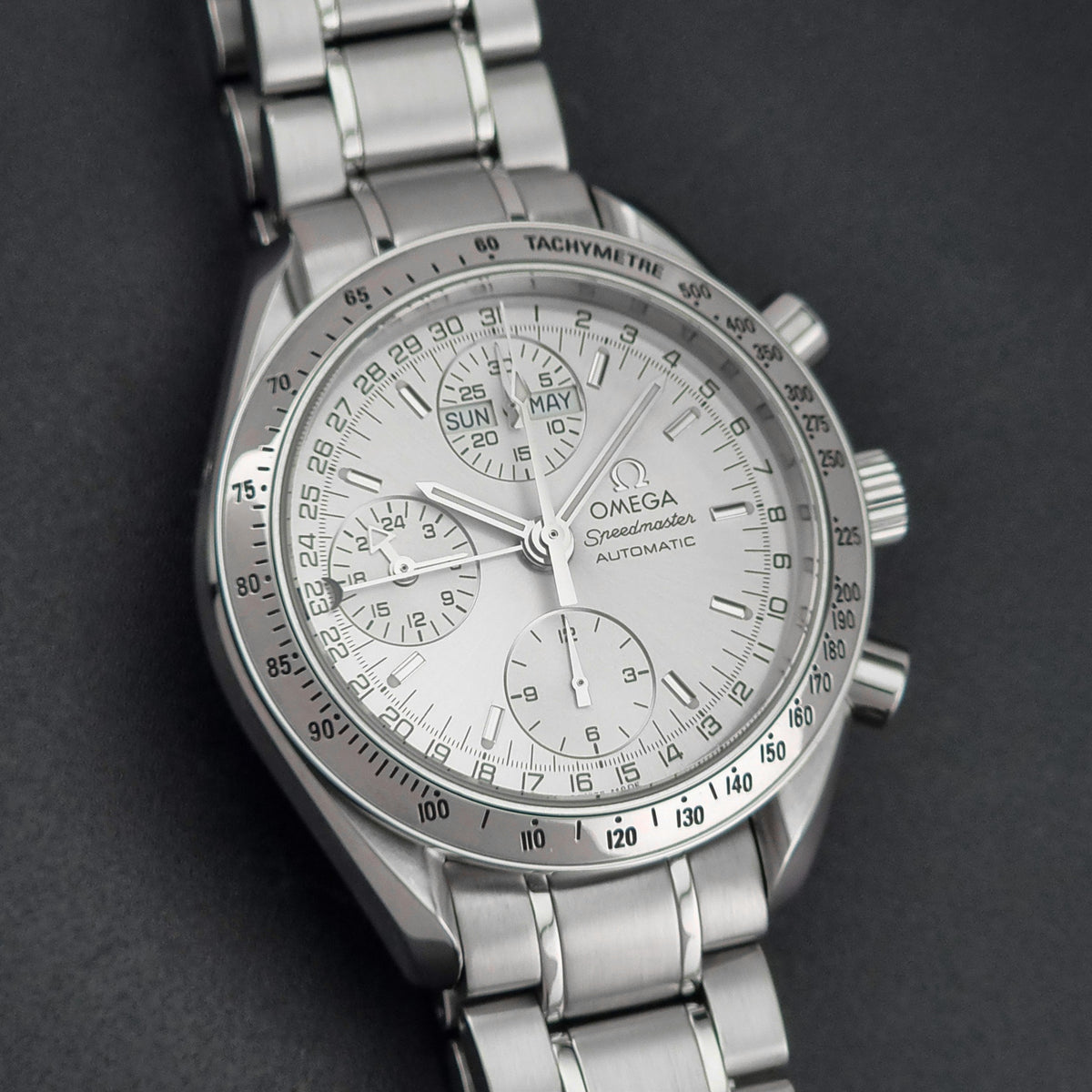 1999 Omega Speedmaster 3523.30 Triple Date automatic chronograph, additional face-on view of the silver sunburst chronograph dial and hands