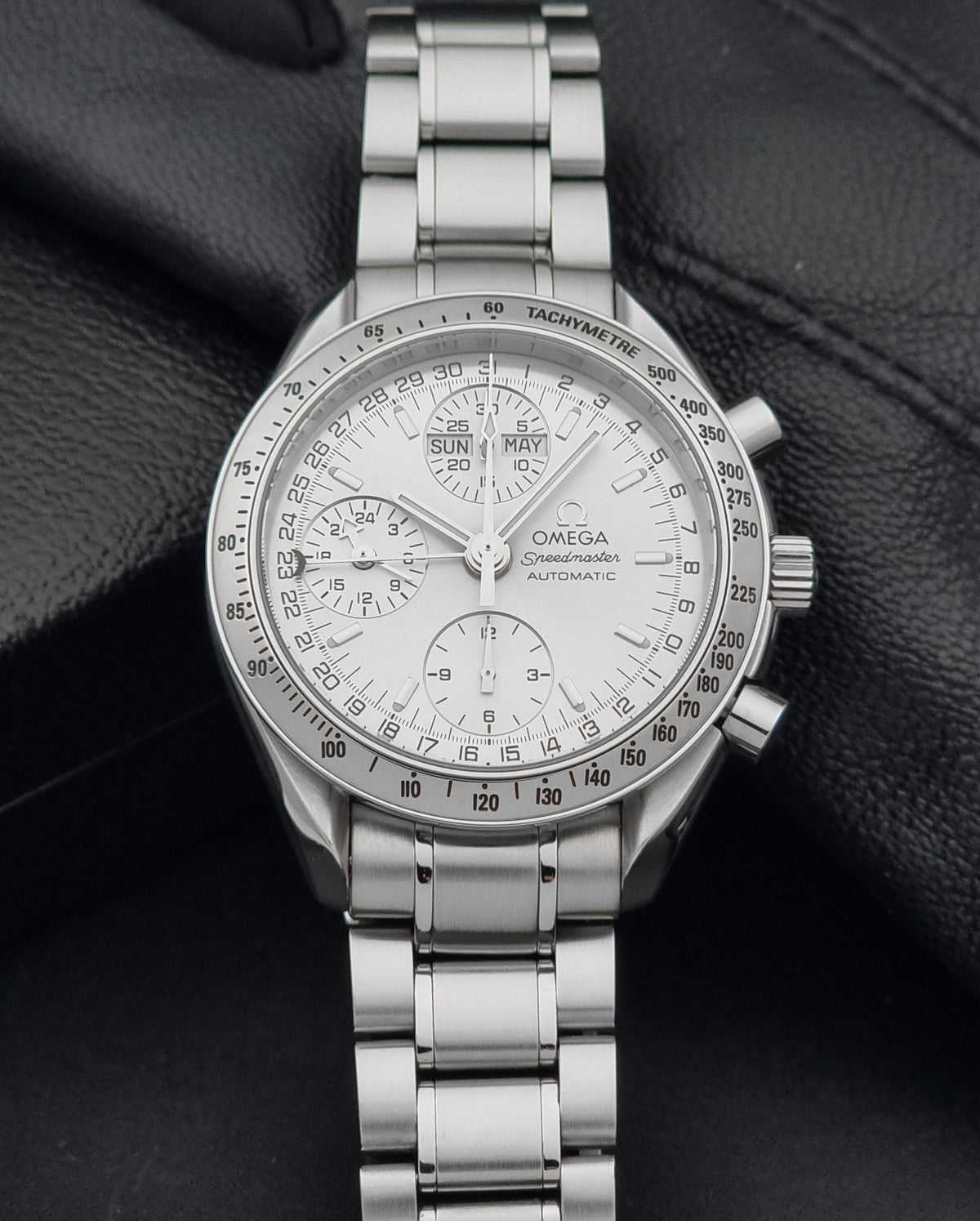 1999 Omega Speedmaster 3523.30 Triple Date automatic chronograph, alternate front view showing the silver sunburst chronograph dial and case