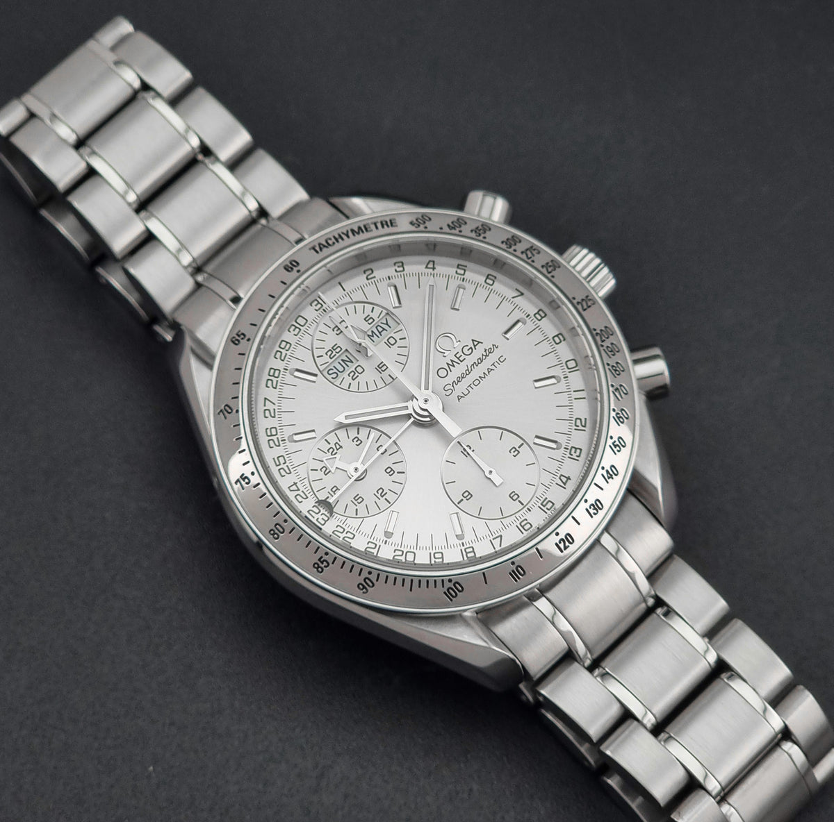 1999 Omega Speedmaster 3523.30 Triple Date automatic chronograph, front view featuring the silver sunburst chronograph dial
