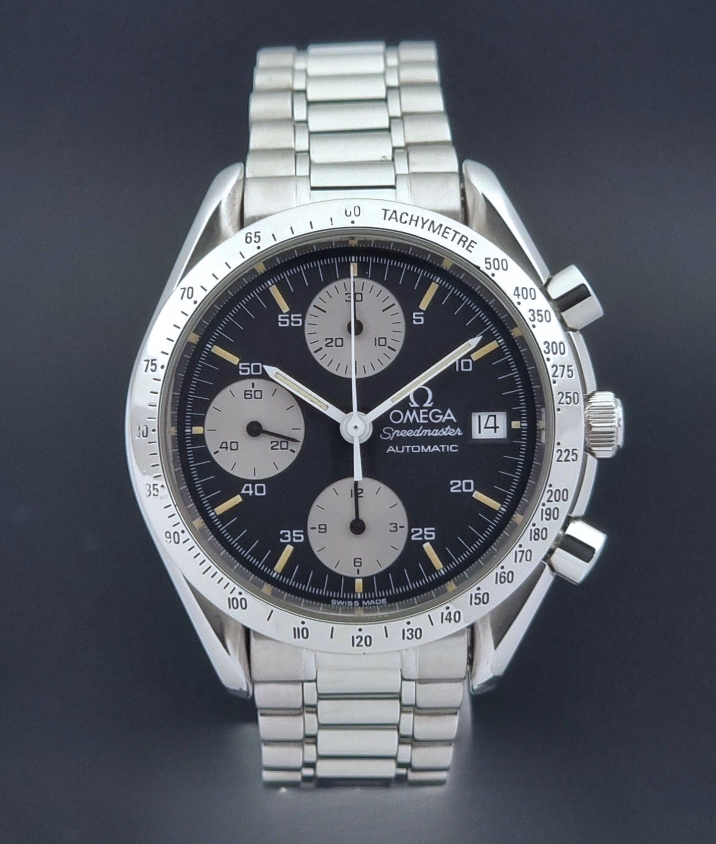 Vintage Omega Speedmaster watch 3511.50  Reverse Panda Date Chronograph with a black face on a dark background close up