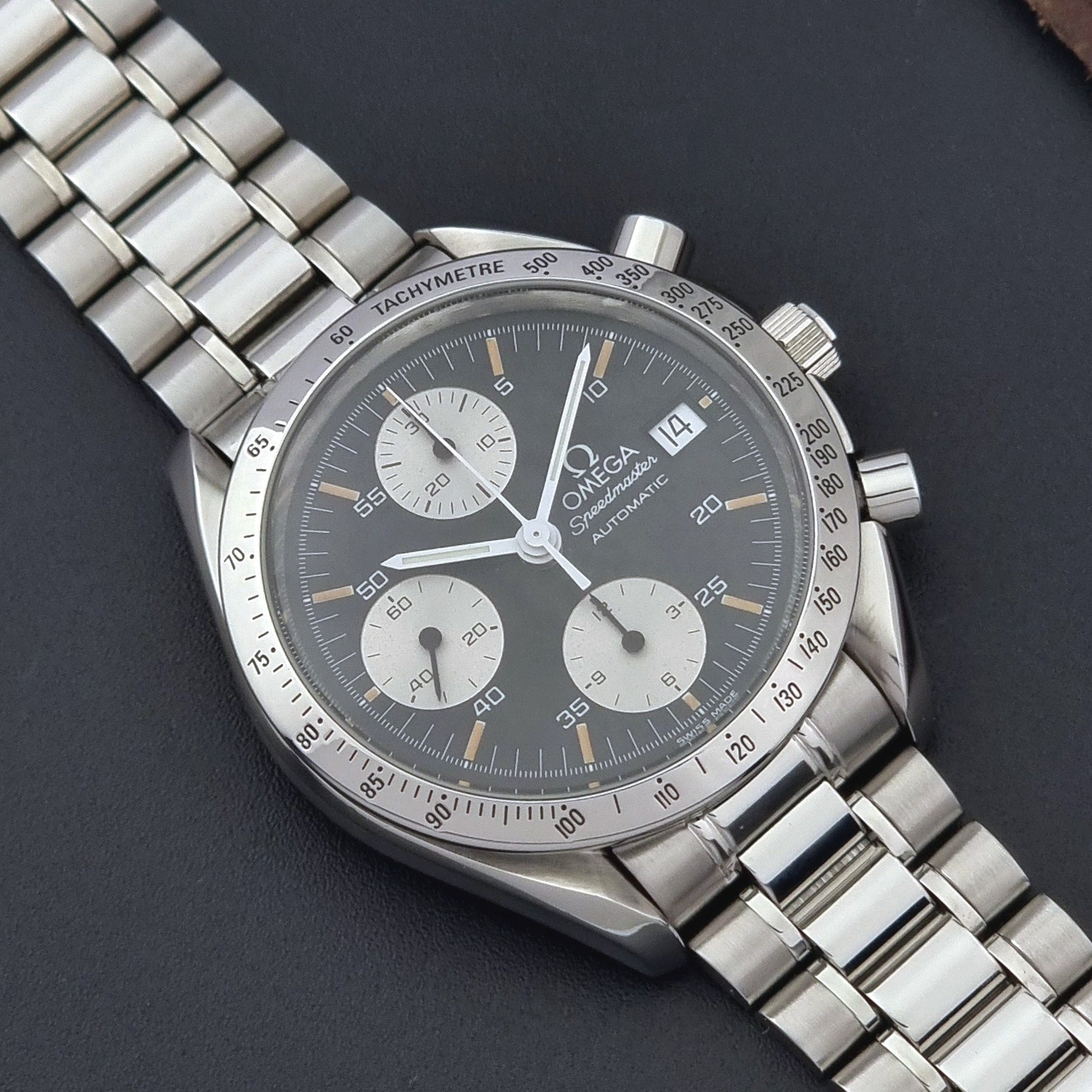 Vintage Omega Speedmaster 3511.50 watch Reverse Panda with a black face on a dark background close up dial view