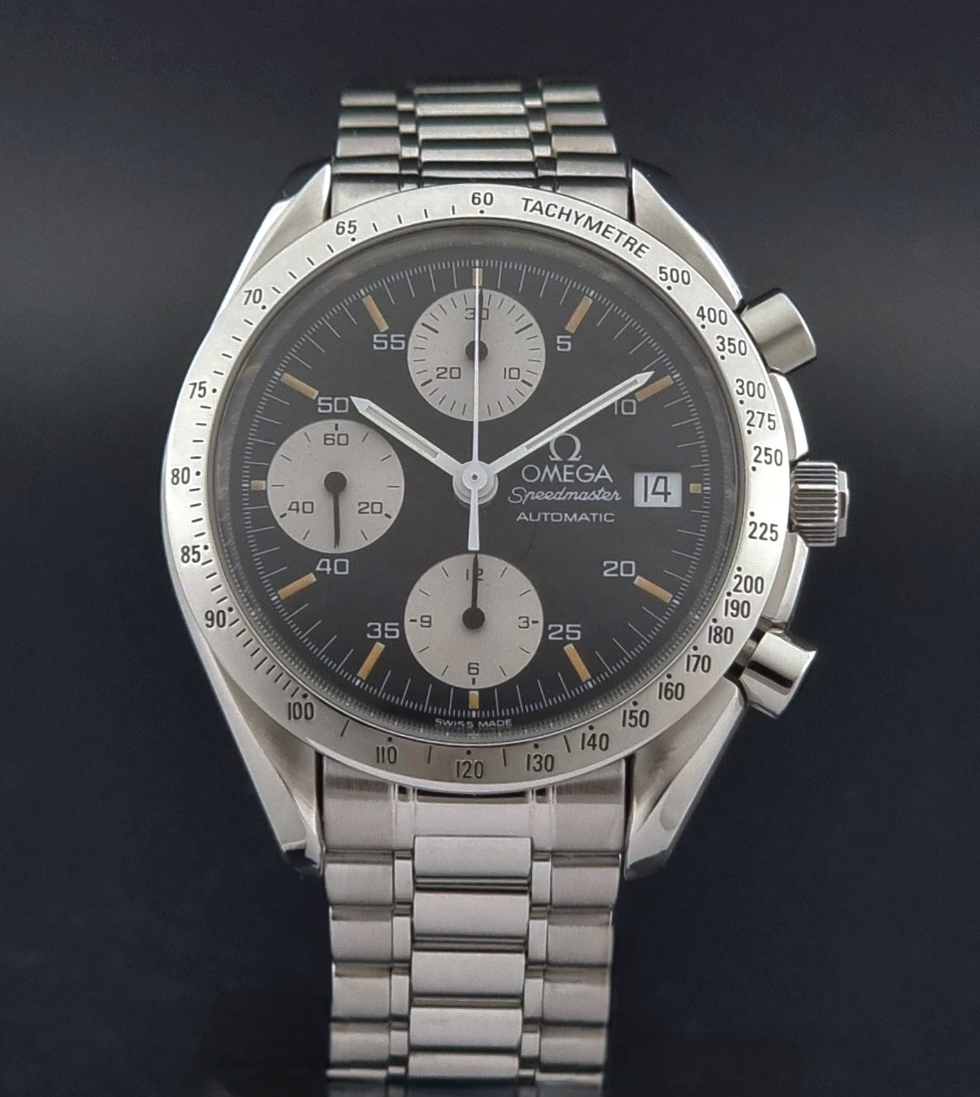 Vintage Omega Speedmaster 3511.50 watch Reverse Panda with a black face on a dark background close dial view