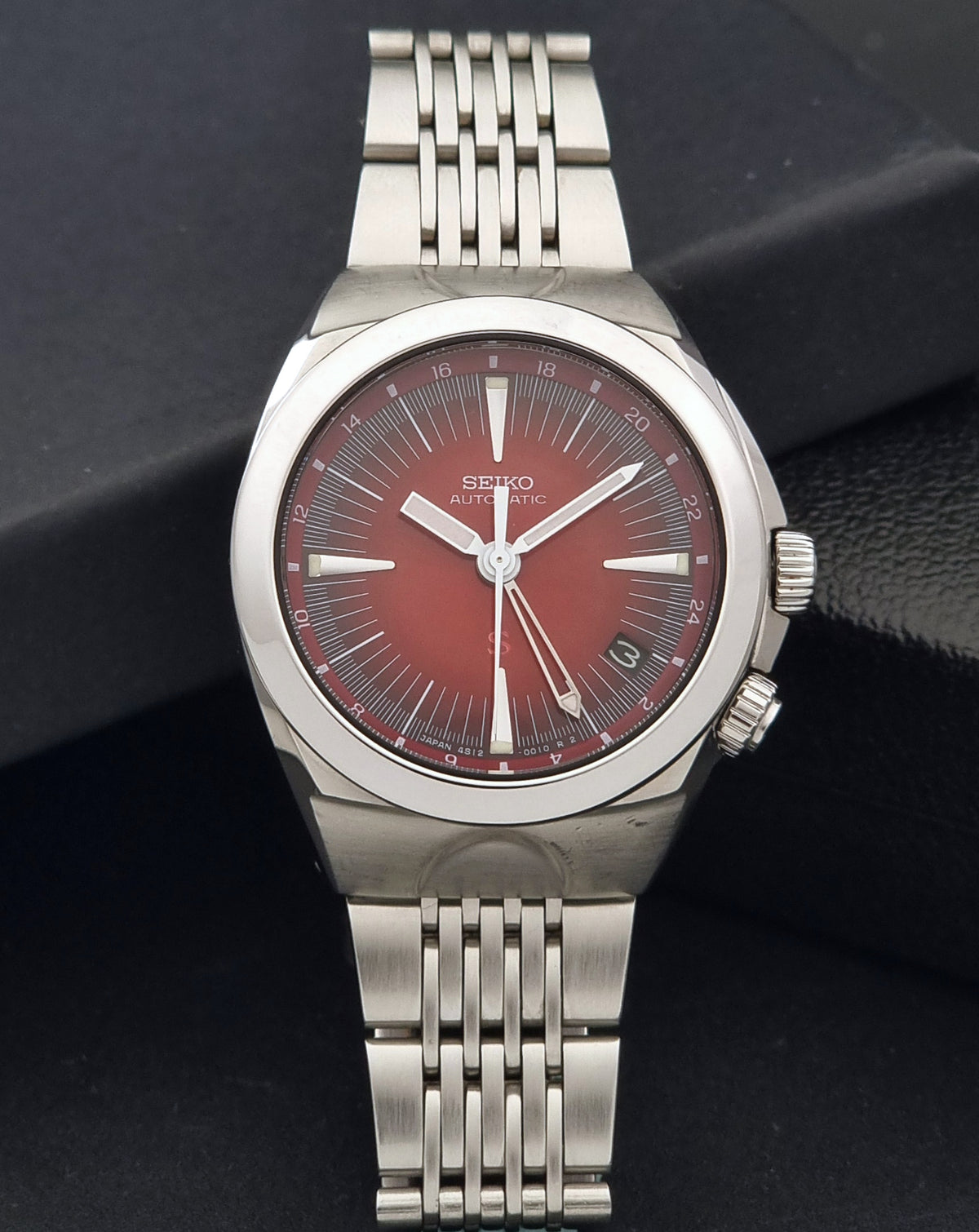 Seiko watch Mechasus SCFF007 GMT 4S12-0010 with a silver stainless steel bracelet and case, featuring a textured red dial with silver-tone hands and markers.