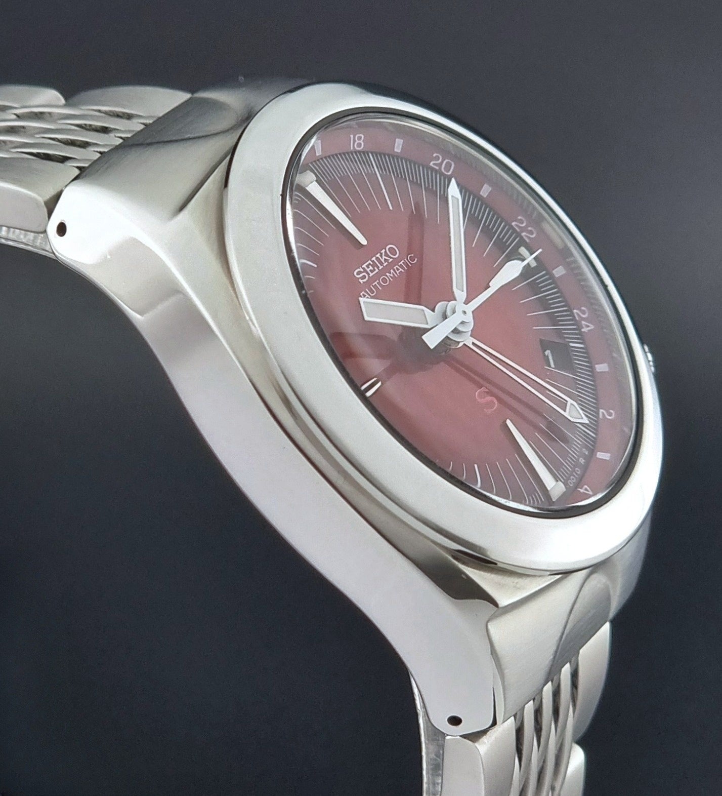 Seiko watch Mechasus SCFF007 GMT 4S12-0010 with a red face on a dark background side profile view
