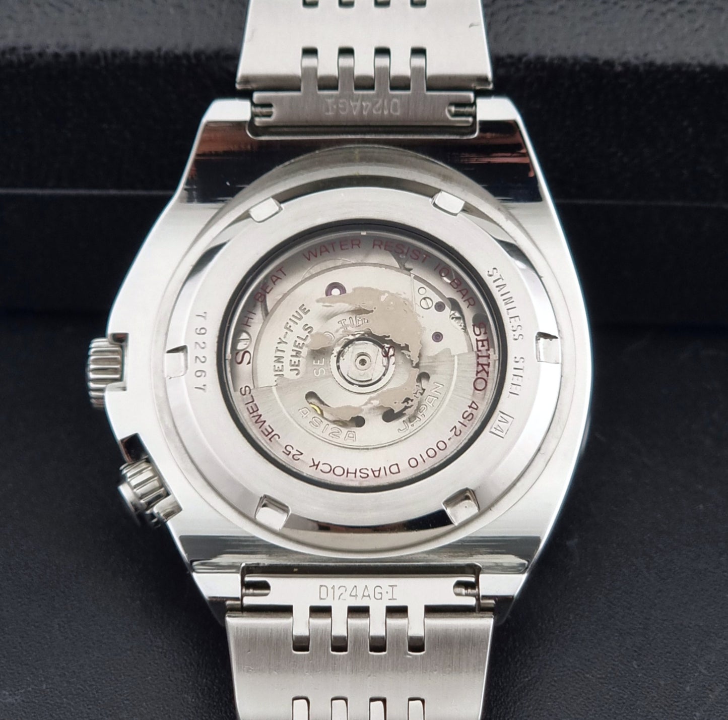 Seiko Mechasus SCFF007 GMT 4S12-0010 wristwatch with a red face on a dark background case back view