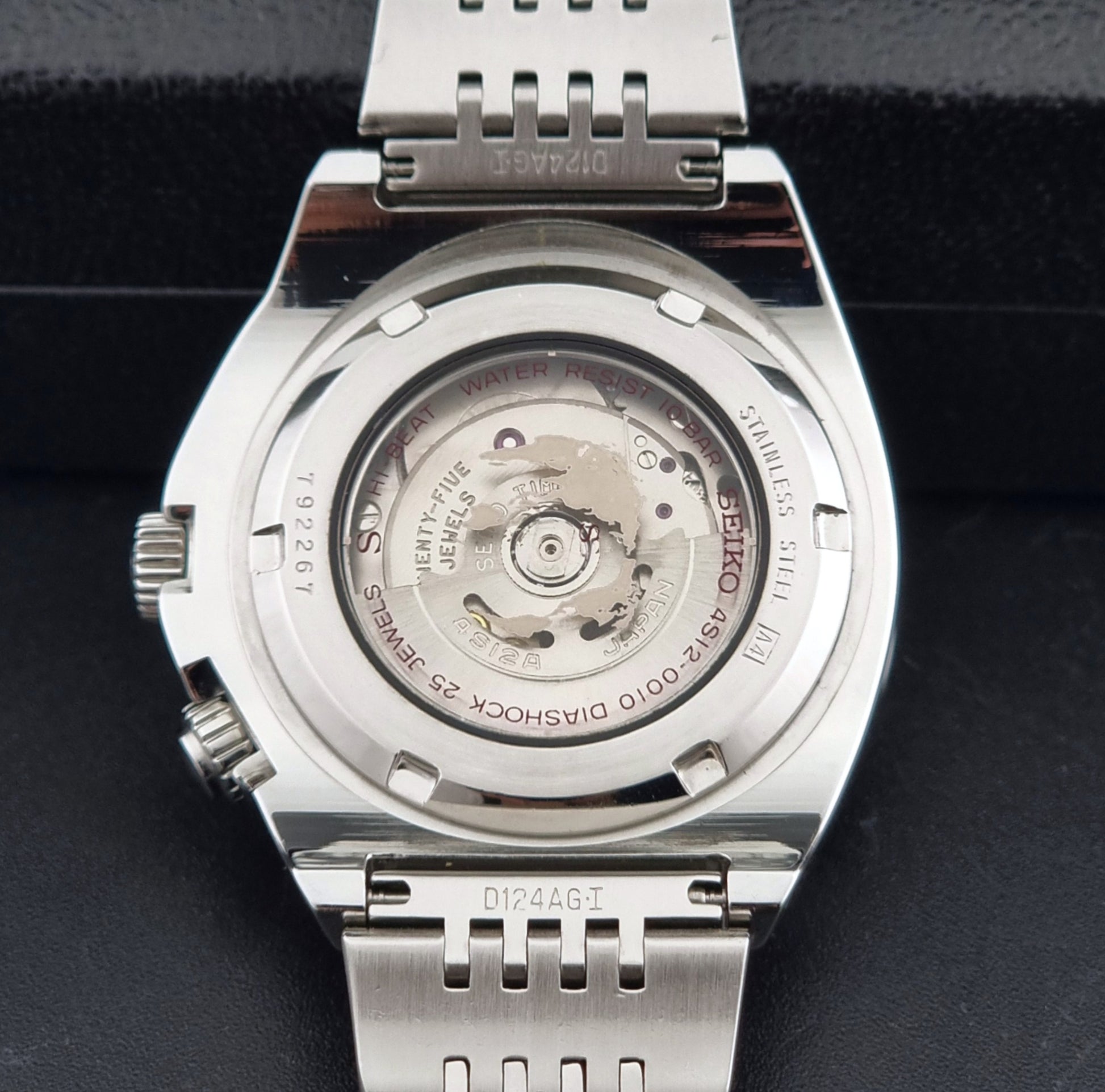 Seiko Mechasus SCFF007 GMT 4S12-0010 wristwatch with a red face on a dark background case back view
