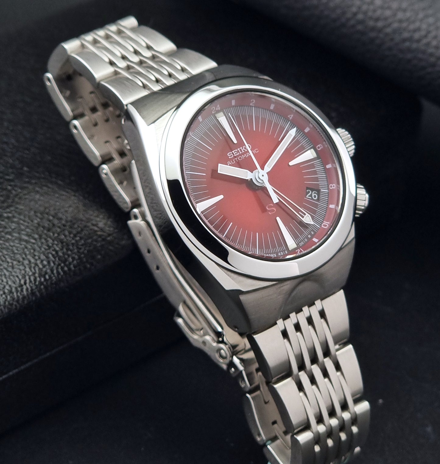 Seiko Mechasus SCFF007 GMT 4S12-0010 wristwatch with a red face on a dark background side view