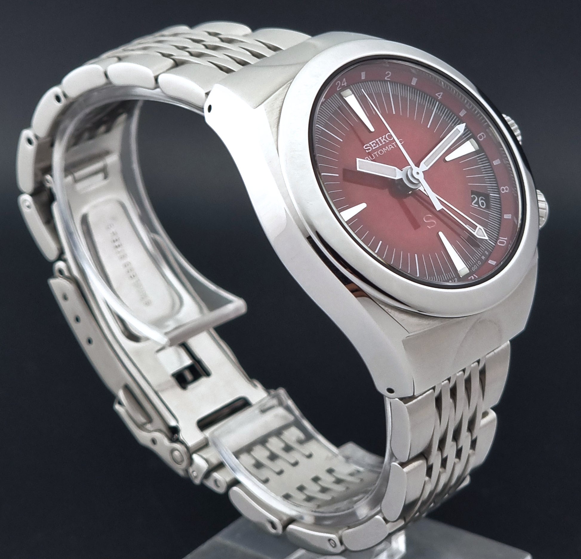 Seiko Mechasus SCFF007 GMT 4S12-0010 wristwatch with a red face on a dark background side profile view