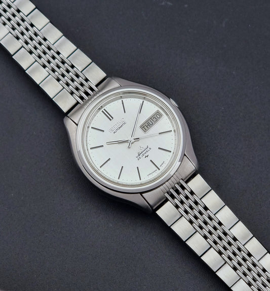 Vintage Seiko watch LordMatic Special 5206-6060 with a white face on a dark gray background dial
