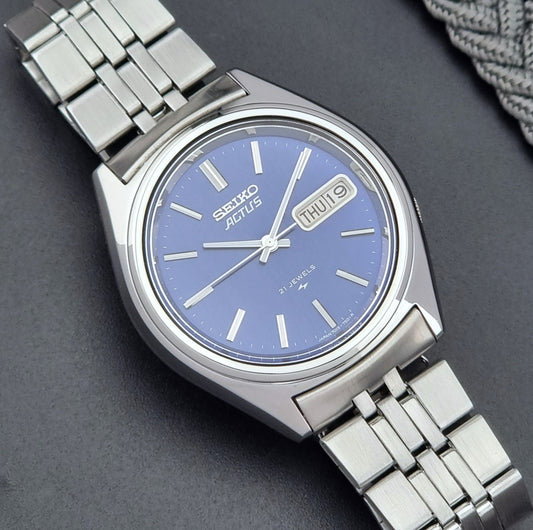 Vintage Seiko Actus Wristwatch 7019-7430 with a blue dial and bracelet on a dark back ground close up dial view