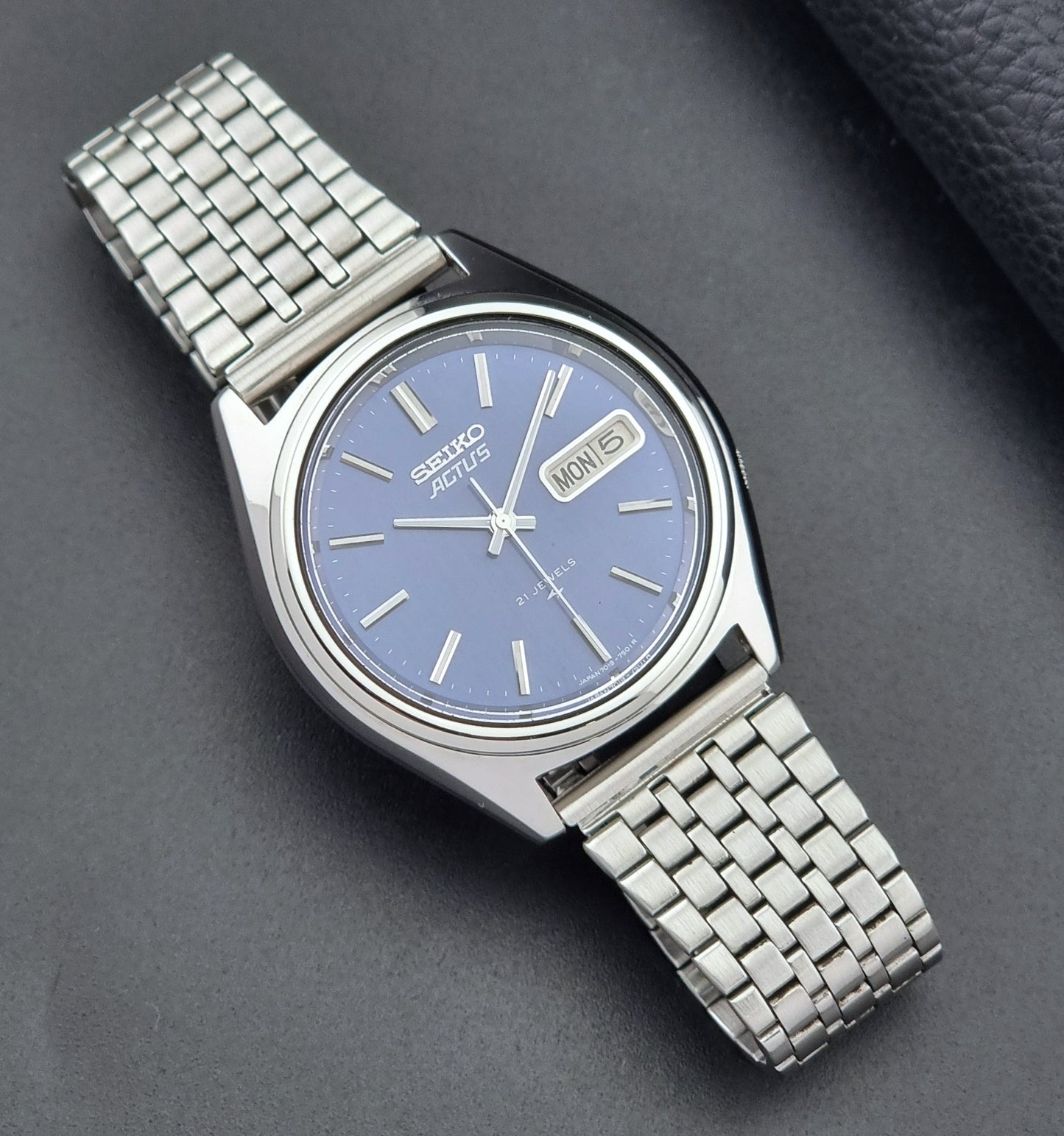 Vintage Seiko Actus Wristwatch 7019-7430 with a blue dial and bracelet on a dark back ground dial