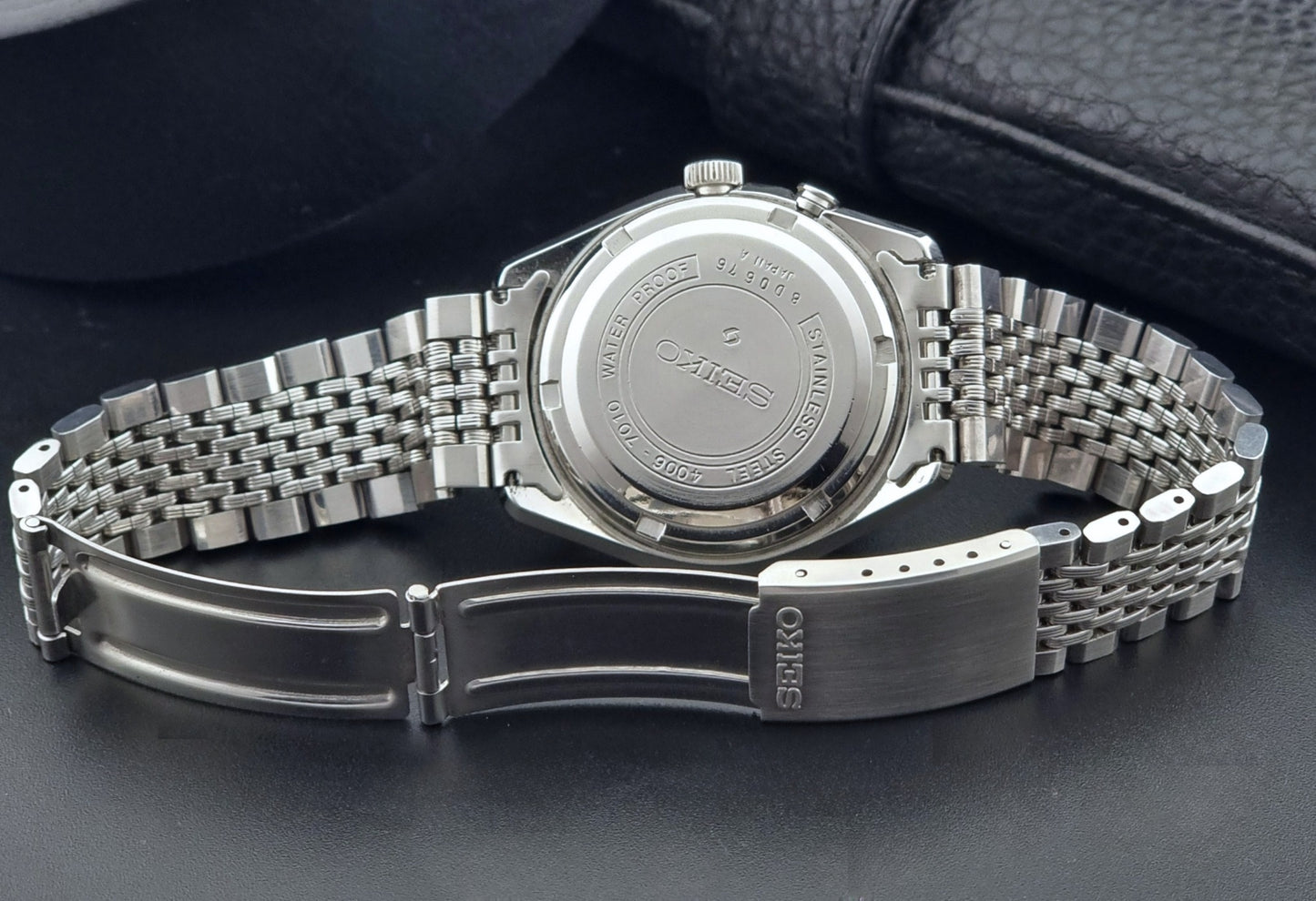 Vintage Seiko Alarm Watch Bell-Matic 4006-7010 with a dark face on a black background case back view