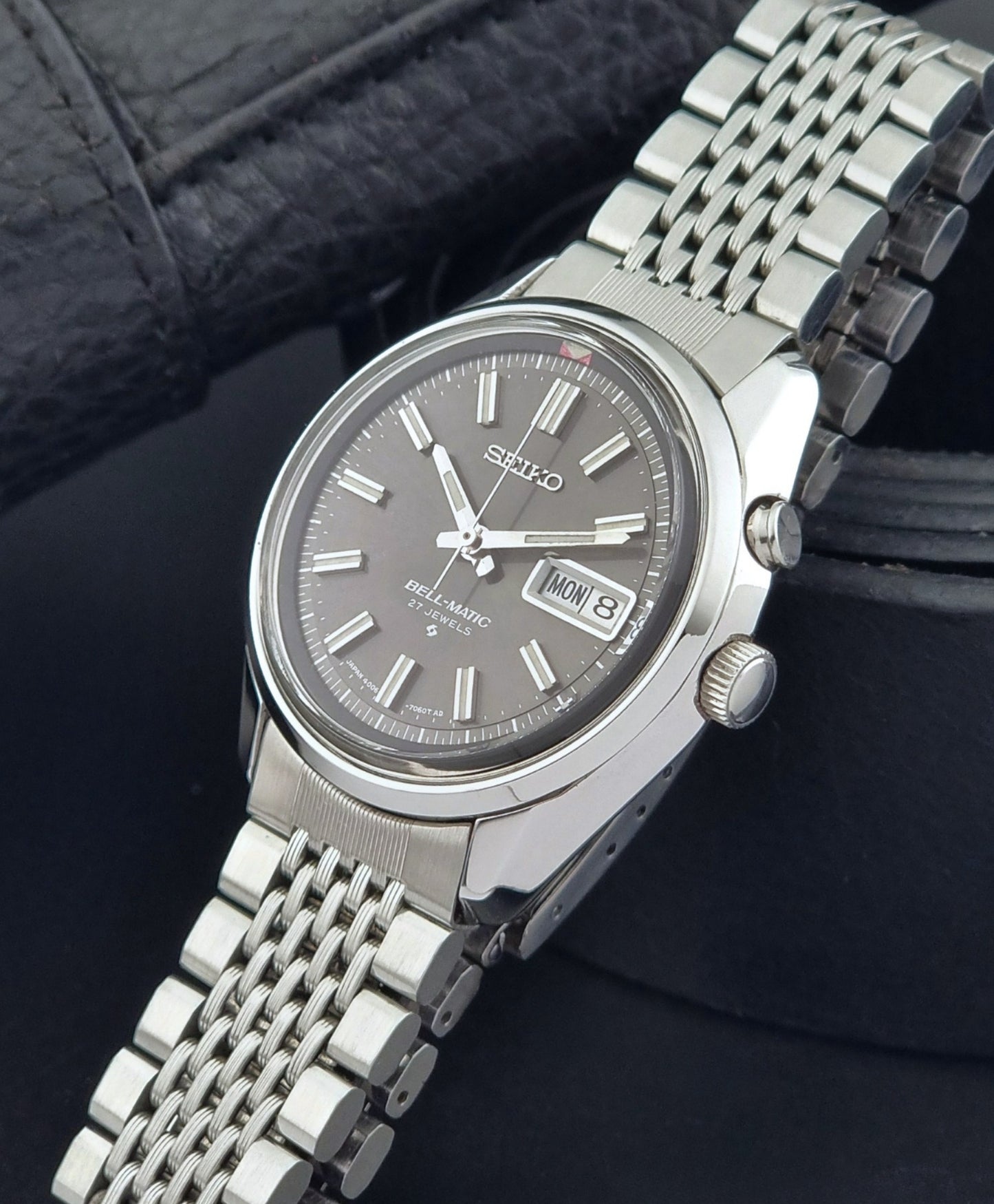 Vintage Seiko Alarm Watch Bell-Matic 4006-7010 with a dark face on a black background crown view