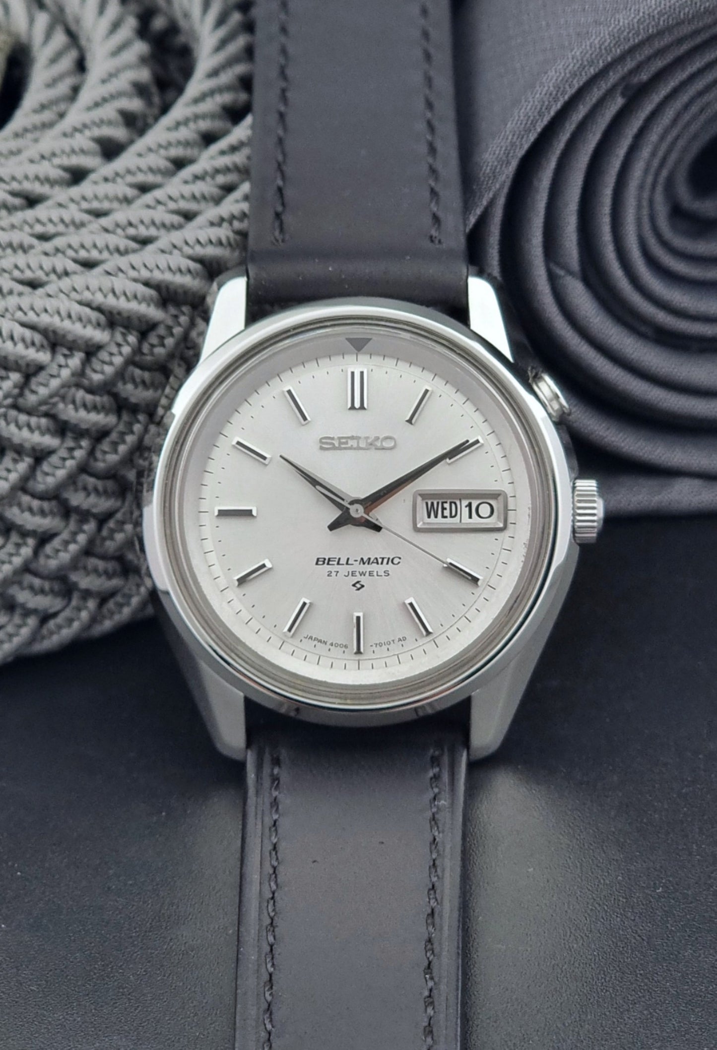 Vintage Seiko Alarm Wristwatch Bell-Matic 4006-7010 with black leather strap on a dark surface dial view