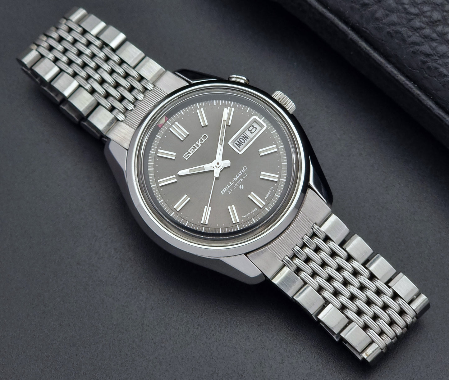 Vintage Seiko Alarm Watch Bell-Matic 4006-7010 with a dark face on a black background front