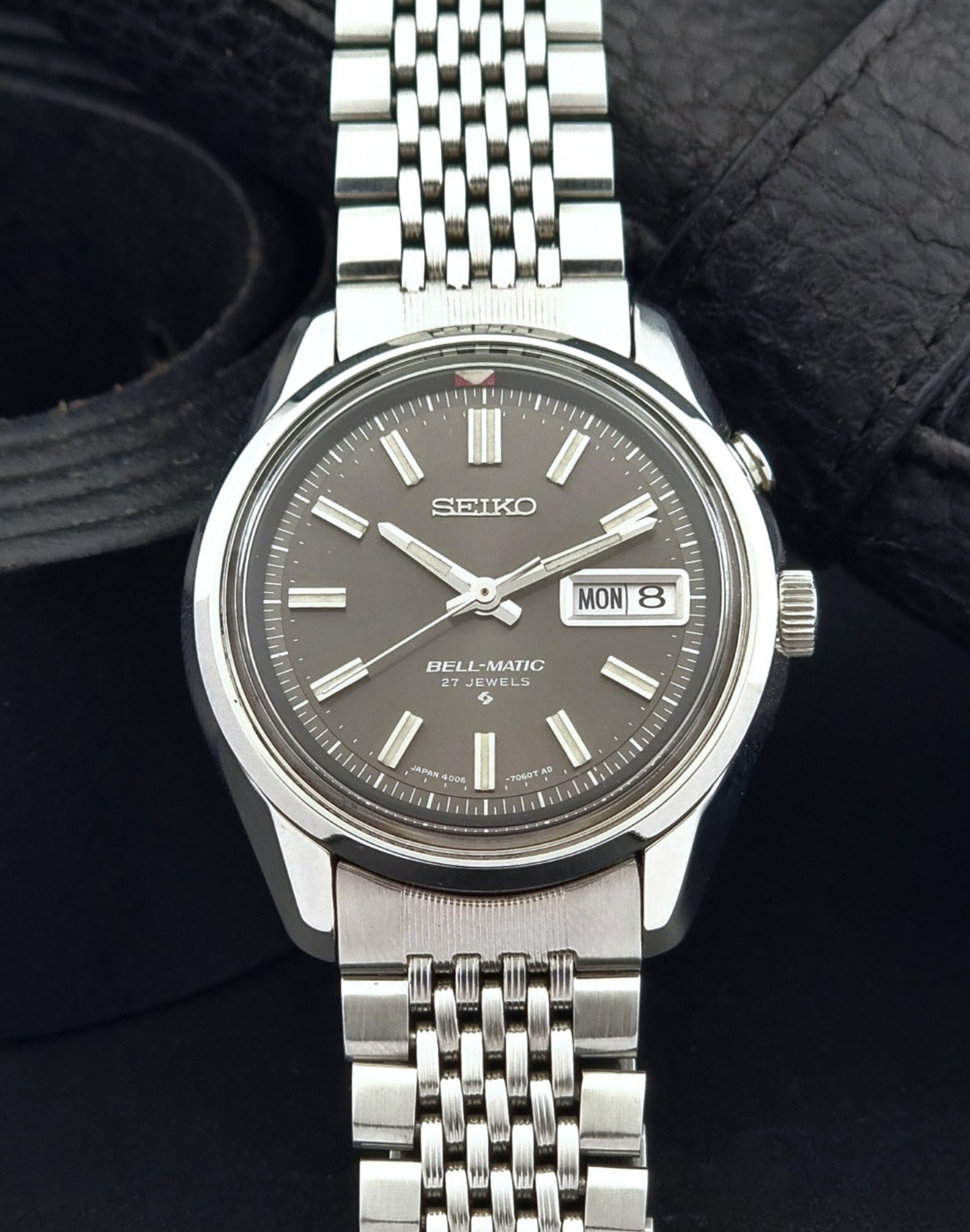 Vintage Seiko Alarm Watch Bell-Matic 4006-7010 with a dark face on a black background dial view