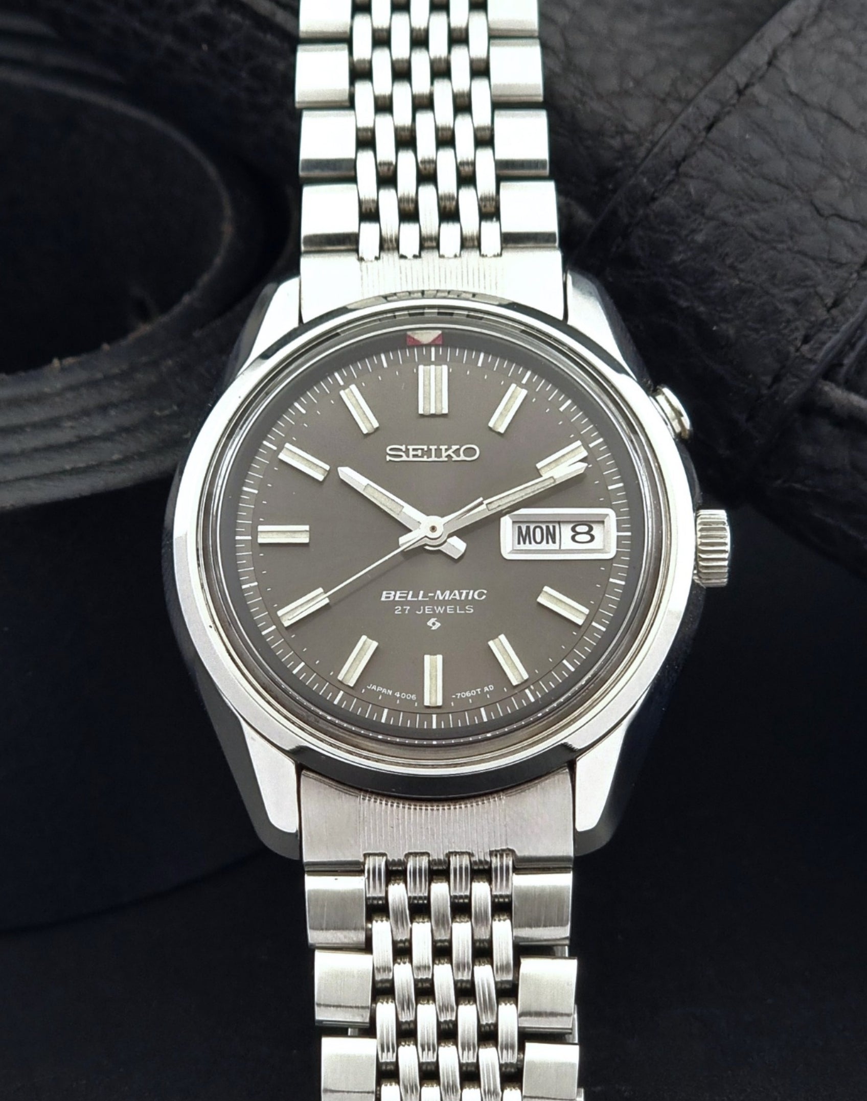 Vintage Seiko Alarm Watch Bell-Matic 4006-7010 with a dark face on a black background dial view