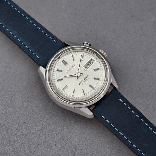 Vintage Seiko Alarm Watch Bell-Matic 4006-7010 with a blue strap on a grey background
