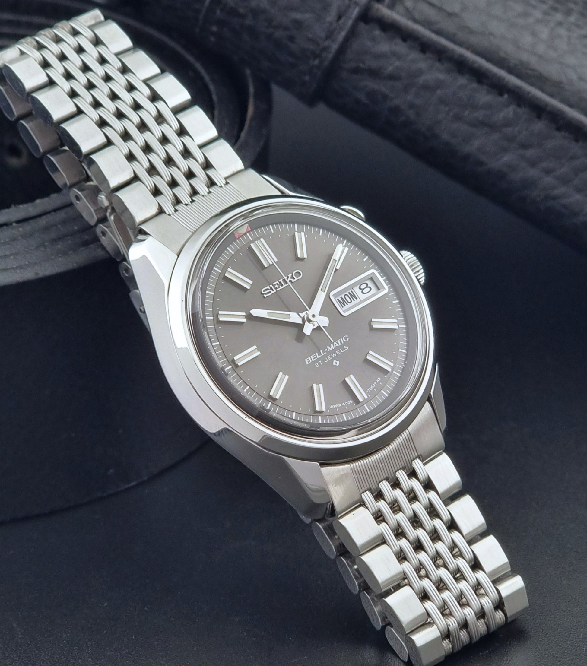 Vintage Seiko Alarm Watch Bell-Matic 4006-7010 with a dark face on a black background side view