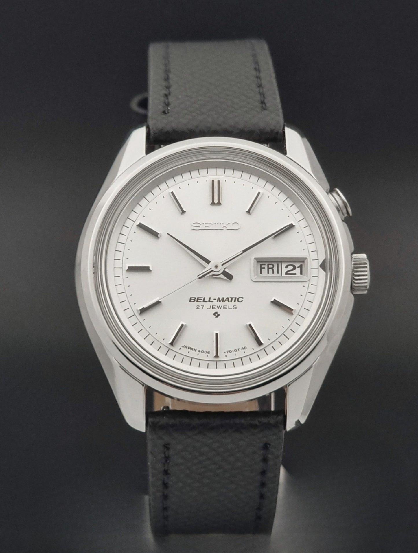 Vintage Seiko Alarm Wristwatch Bell-Matic 4006-7011 with a black strap on a dark background close dial view