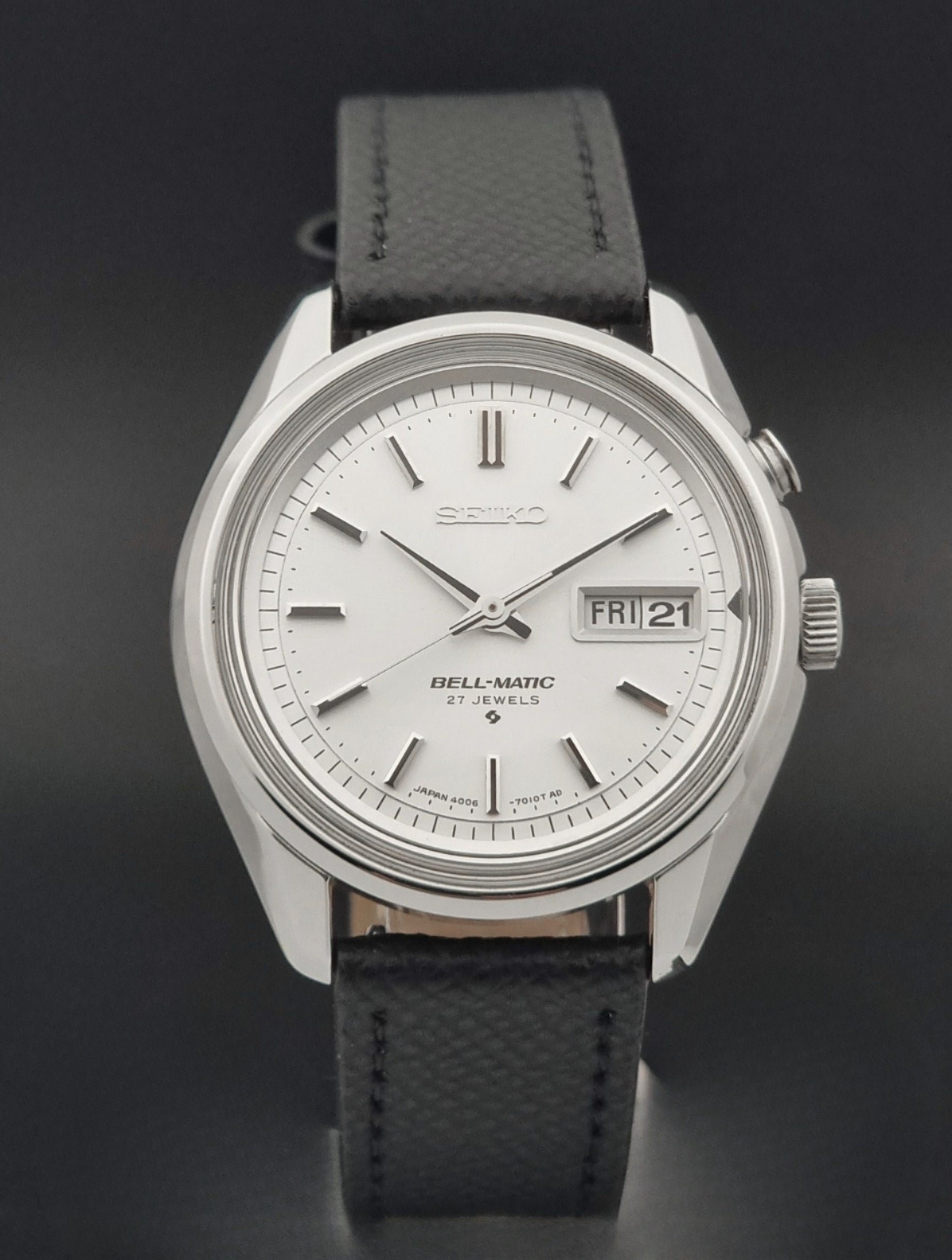Vintage Seiko Alarm Wristwatch Bell-Matic 4006-7011 with a black strap on a dark background close dial view