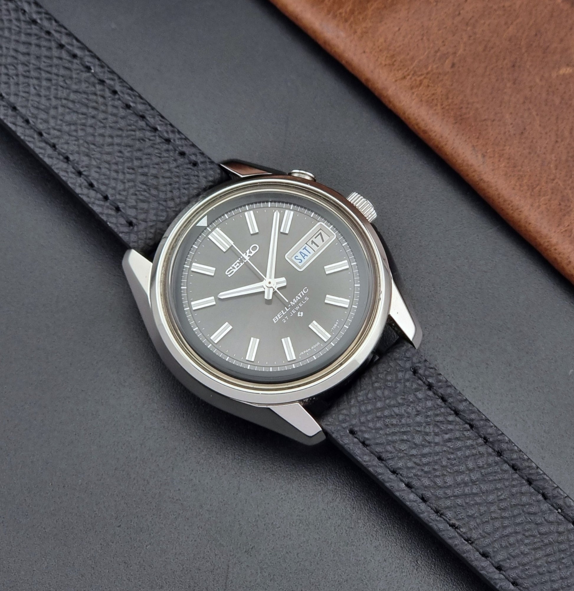 Vintage Seiko Alarm Watch Bell-Matic 4006-7012 with a grey dial and black leather strap on a dark surface dial