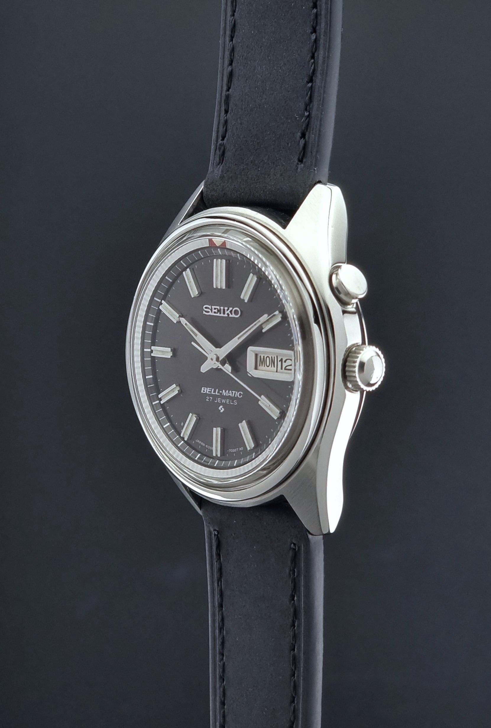 Vintage Seiko Bell-Matic watch with black leather strap on a dark background