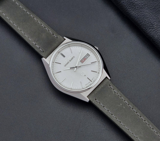 Vintage Seiko Grand Quartz watch 9943-8010 with grey leather strap on a dark background dial