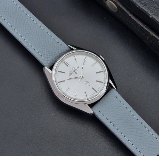 Vintage Seiko King Quartz watch 4821-8000 with light grey leather strap on a dark gray background dial 