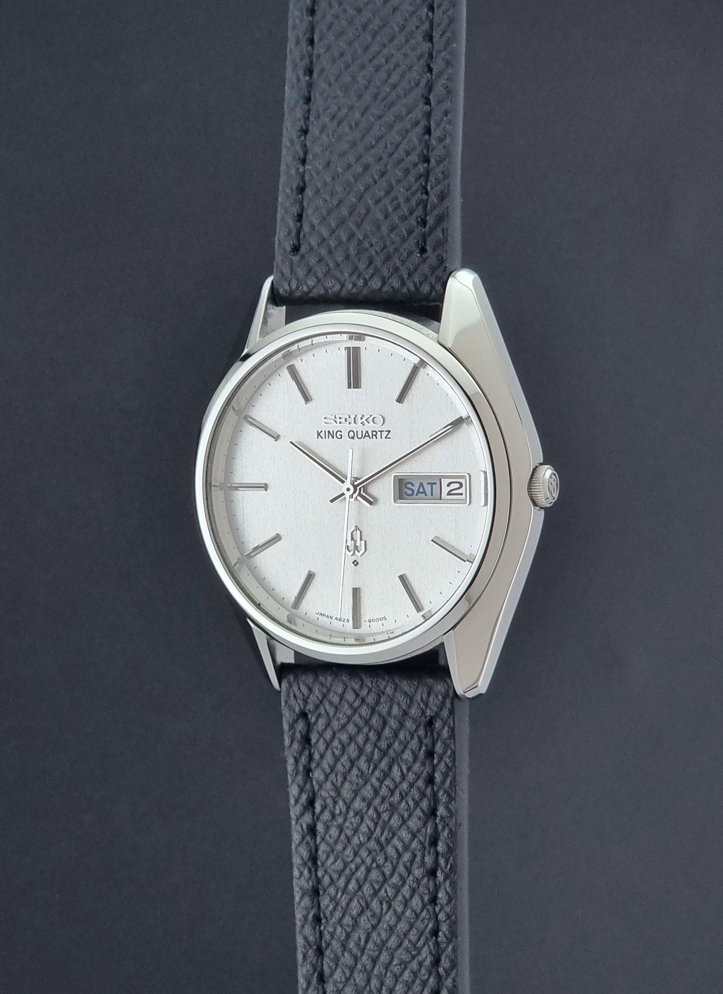 Vintage Seiko King Quartz watch 4823-8000  with black leather strap on a dark background crown profile view