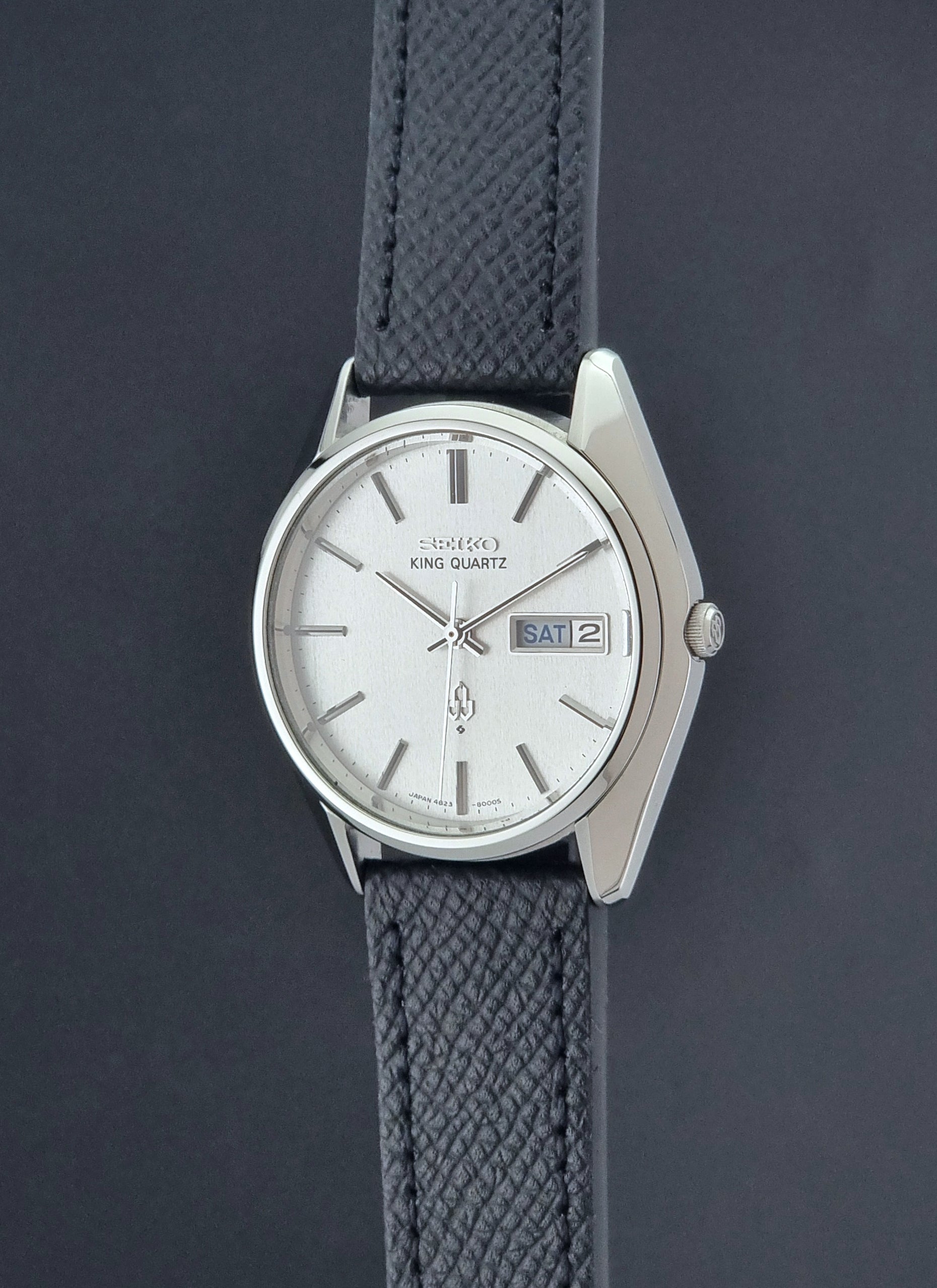 Vintage Seiko King Quartz watch 4823-8000  with black leather strap on a dark background crown profile view