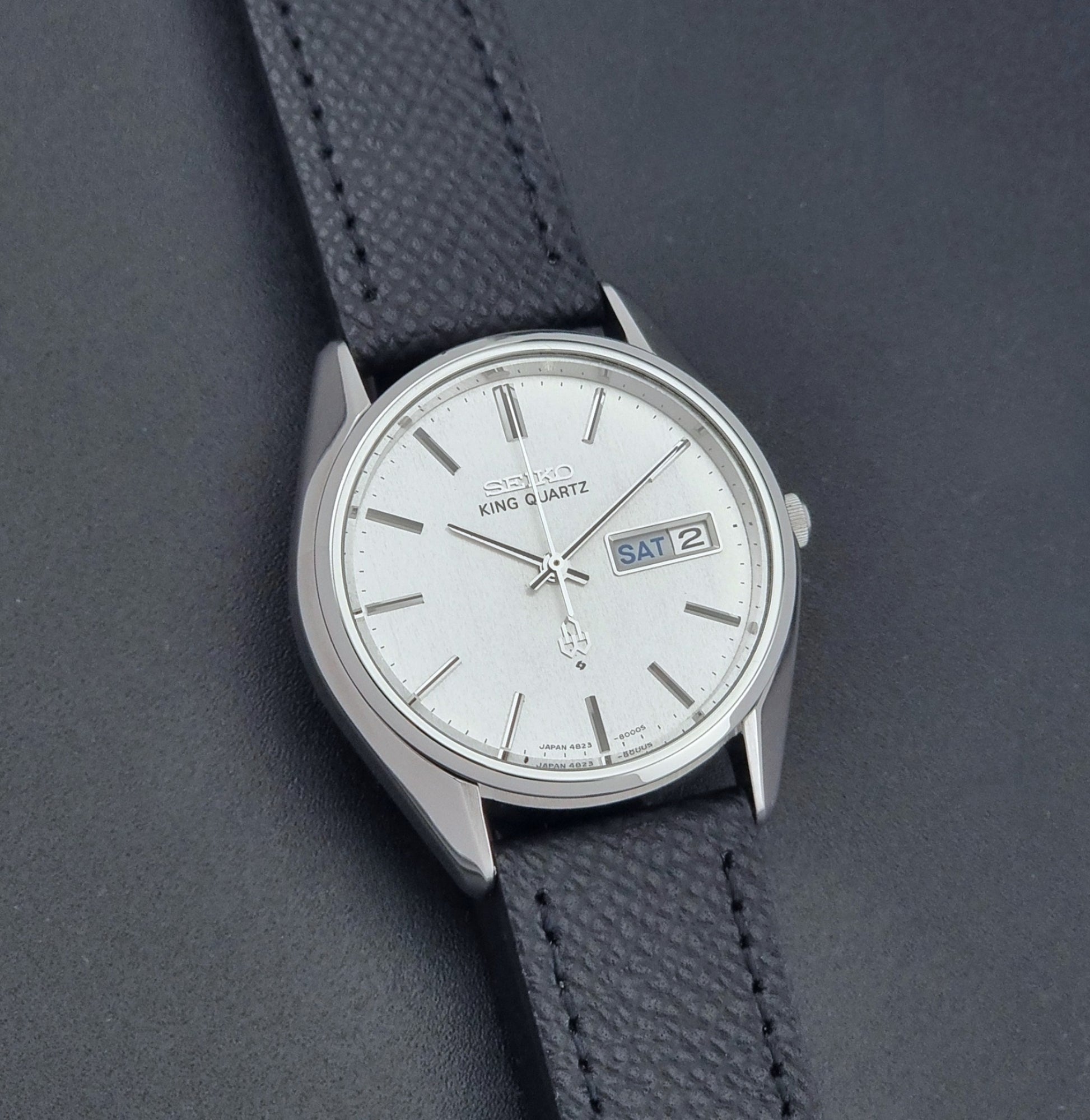 Vintage Seiko King Quartz watch 4823-8000  with black leather strap on a dark background front view