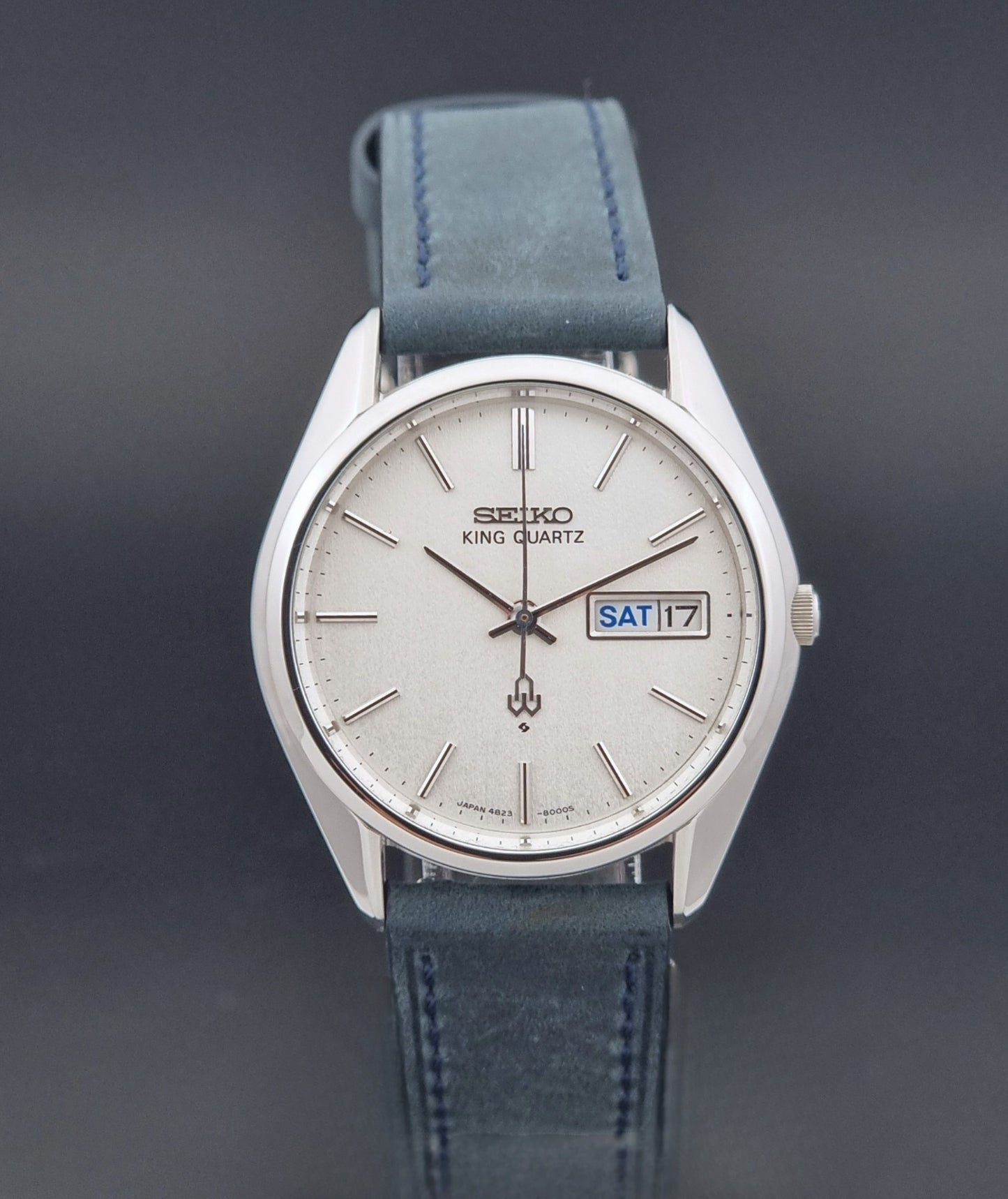 Vintage Seiko King Quartz 4823-8000-G with a blue leather strap on a dark background close dial view