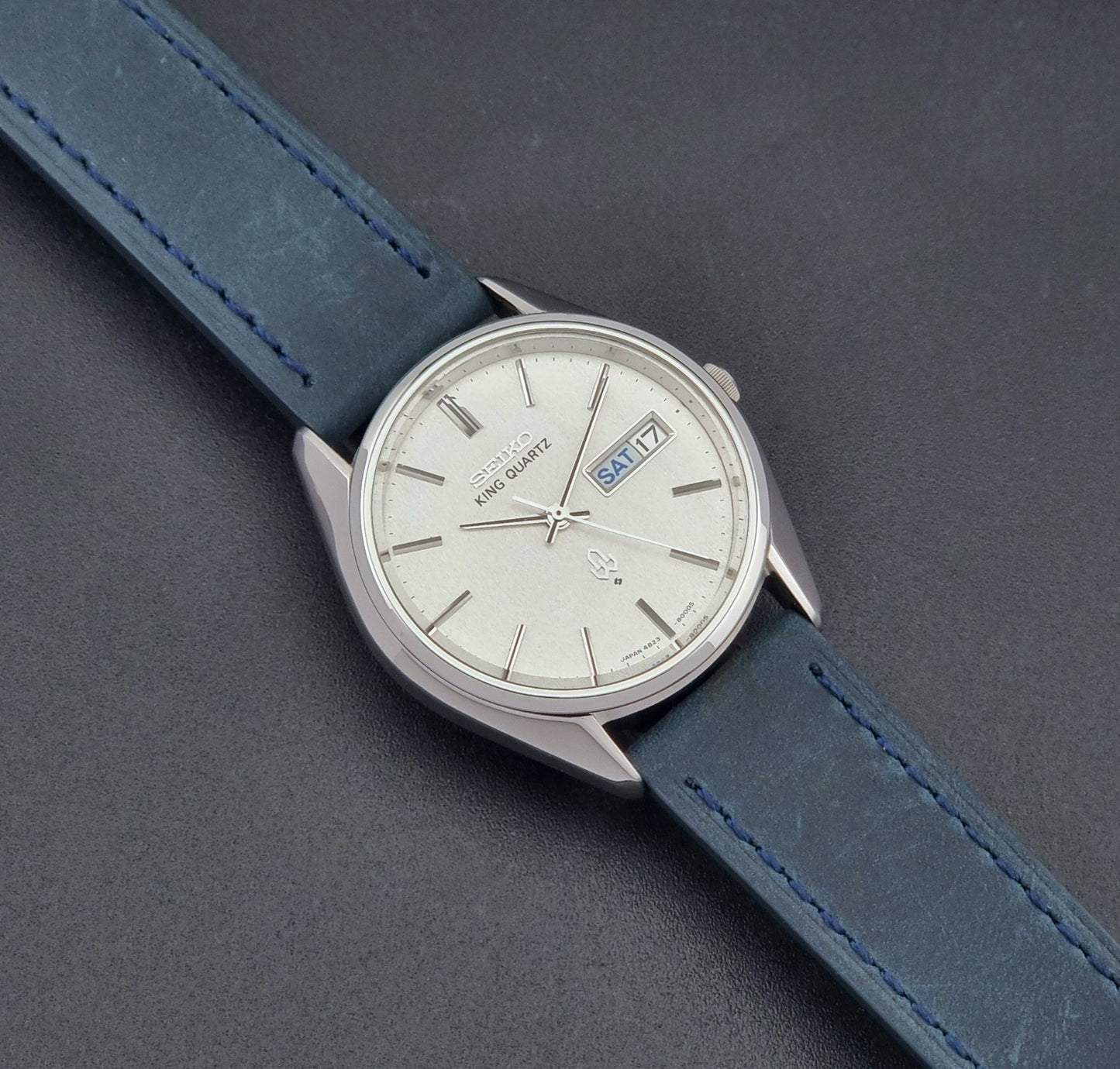 Vintage Seiko King Quartz 4823-8000-G with a blue leather strap on a dark background dial