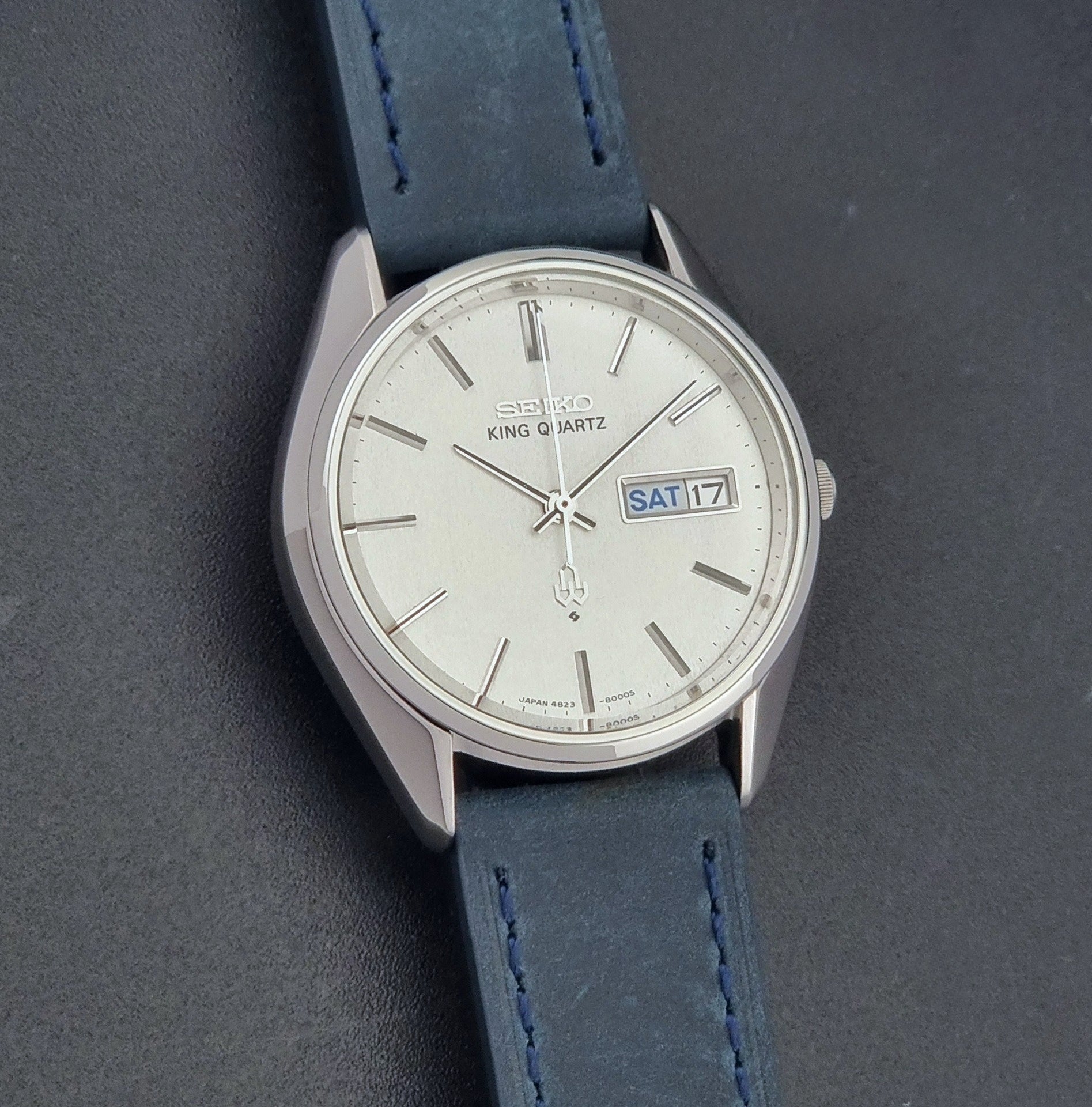 Vintage Seiko King Quartz 4823-8000-G with a blue leather strap on a dark background front view