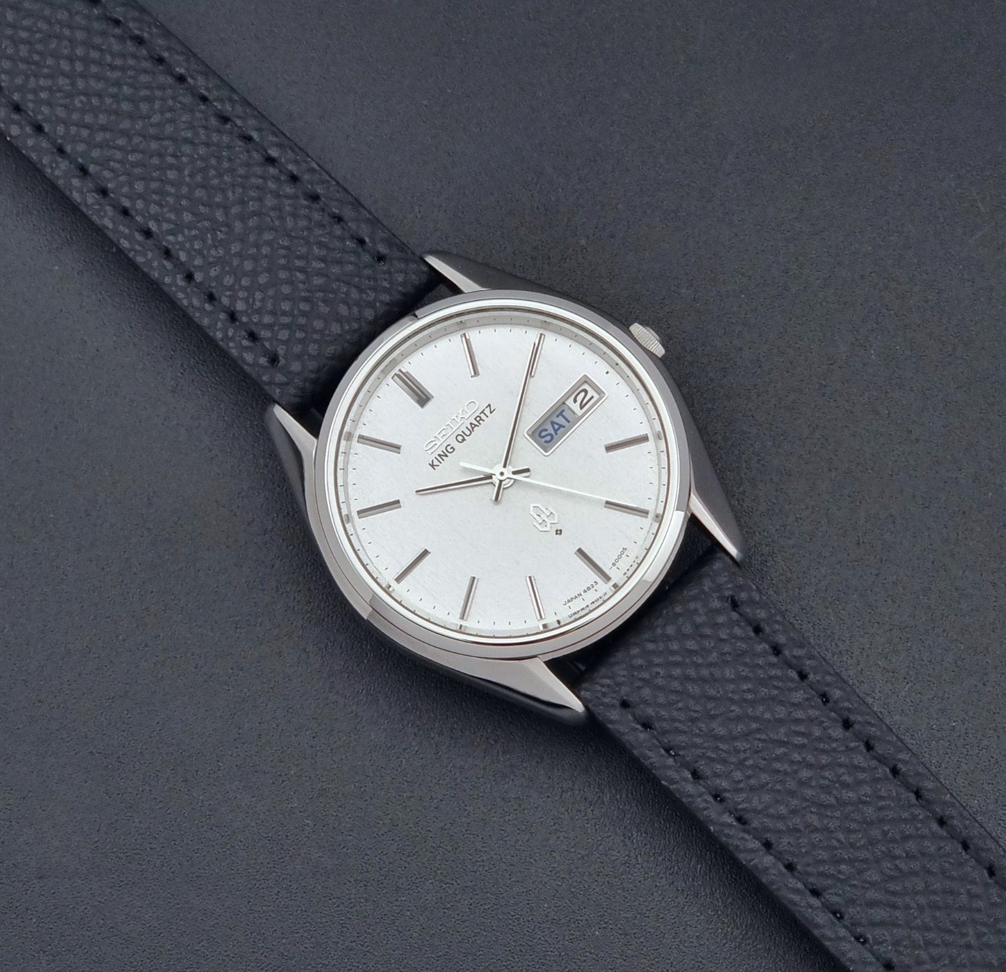 Vintage Seiko King Quartz watch 4823-8000  with black leather strap on a dark background dial 