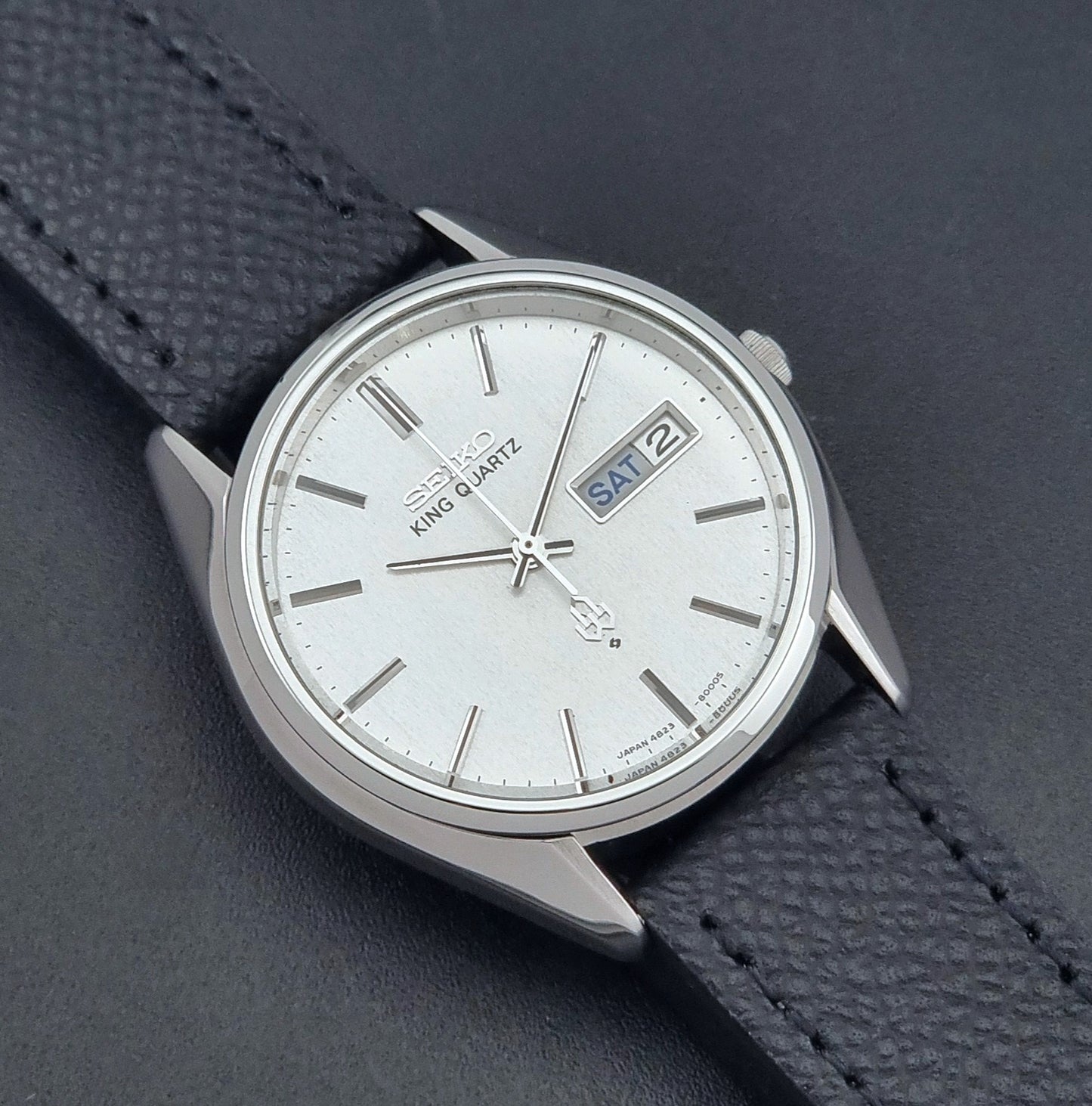 Vintage Seiko King Quartz watch 4823-8000  with black leather strap on a dark background close up dial view