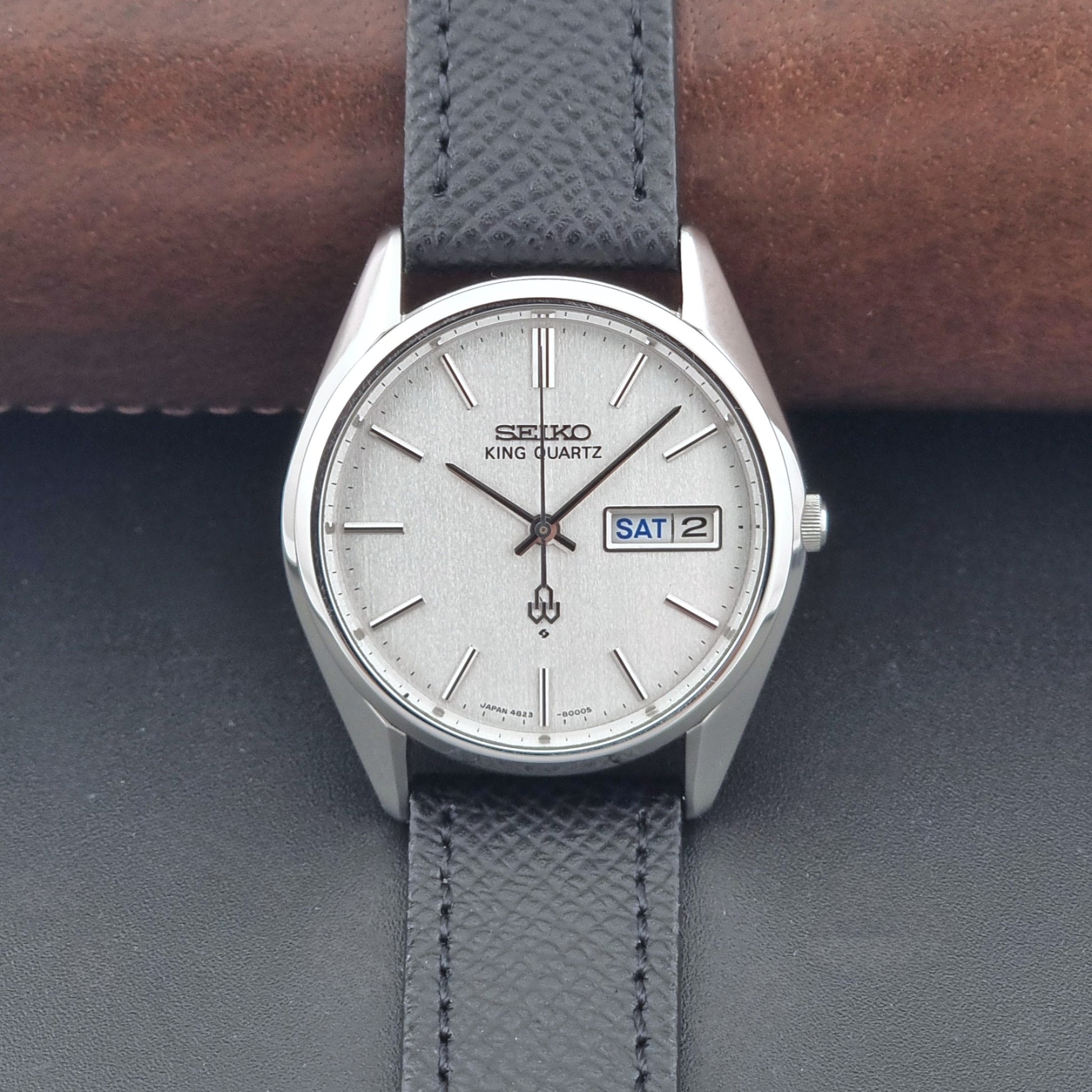 Vintage Seiko King Quartz watch 4823-8000  with black leather strap on a dark background dial view