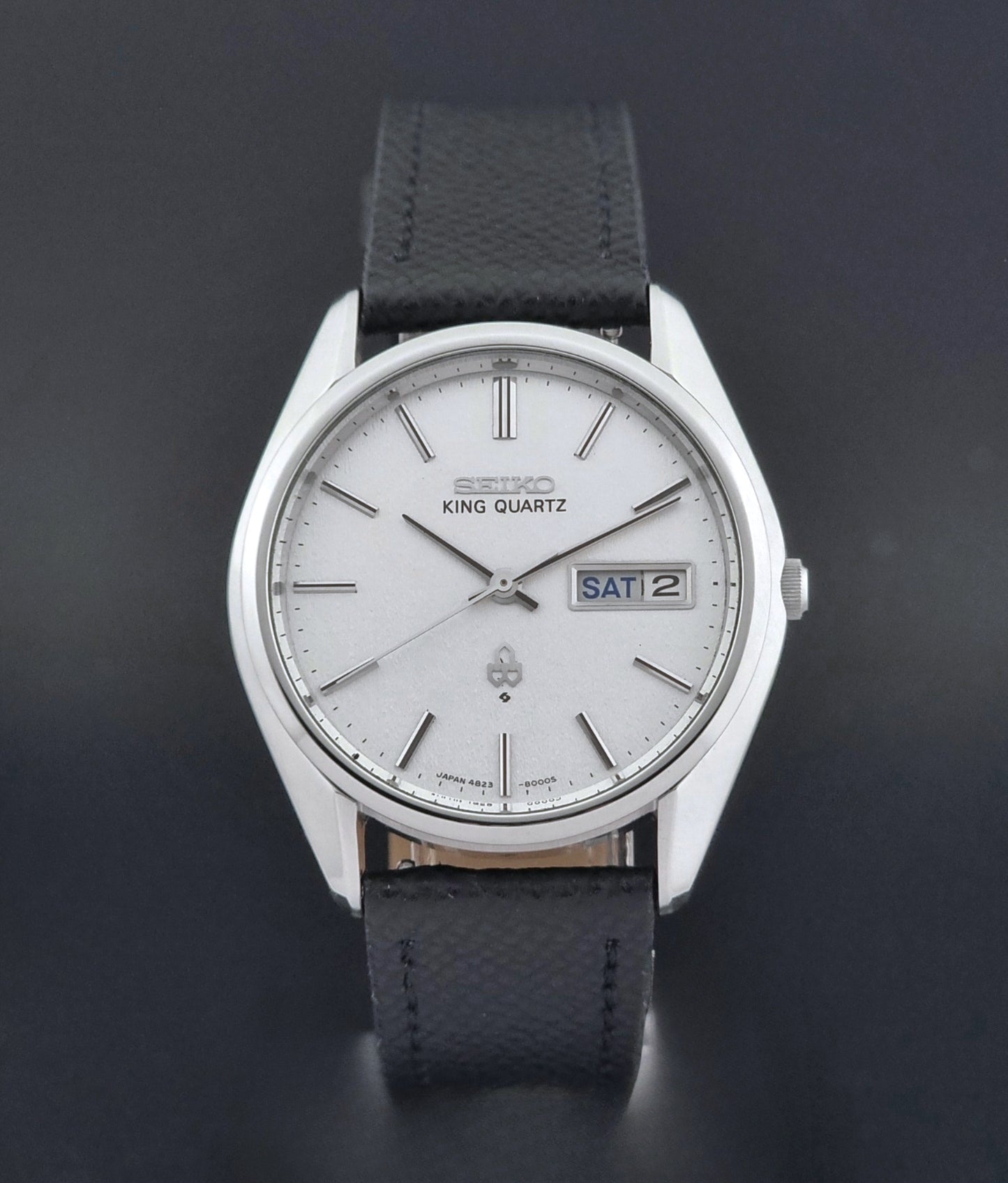 Vintage Seiko King Quartz watch 4823-8000  with black leather strap on a dark background close dial view