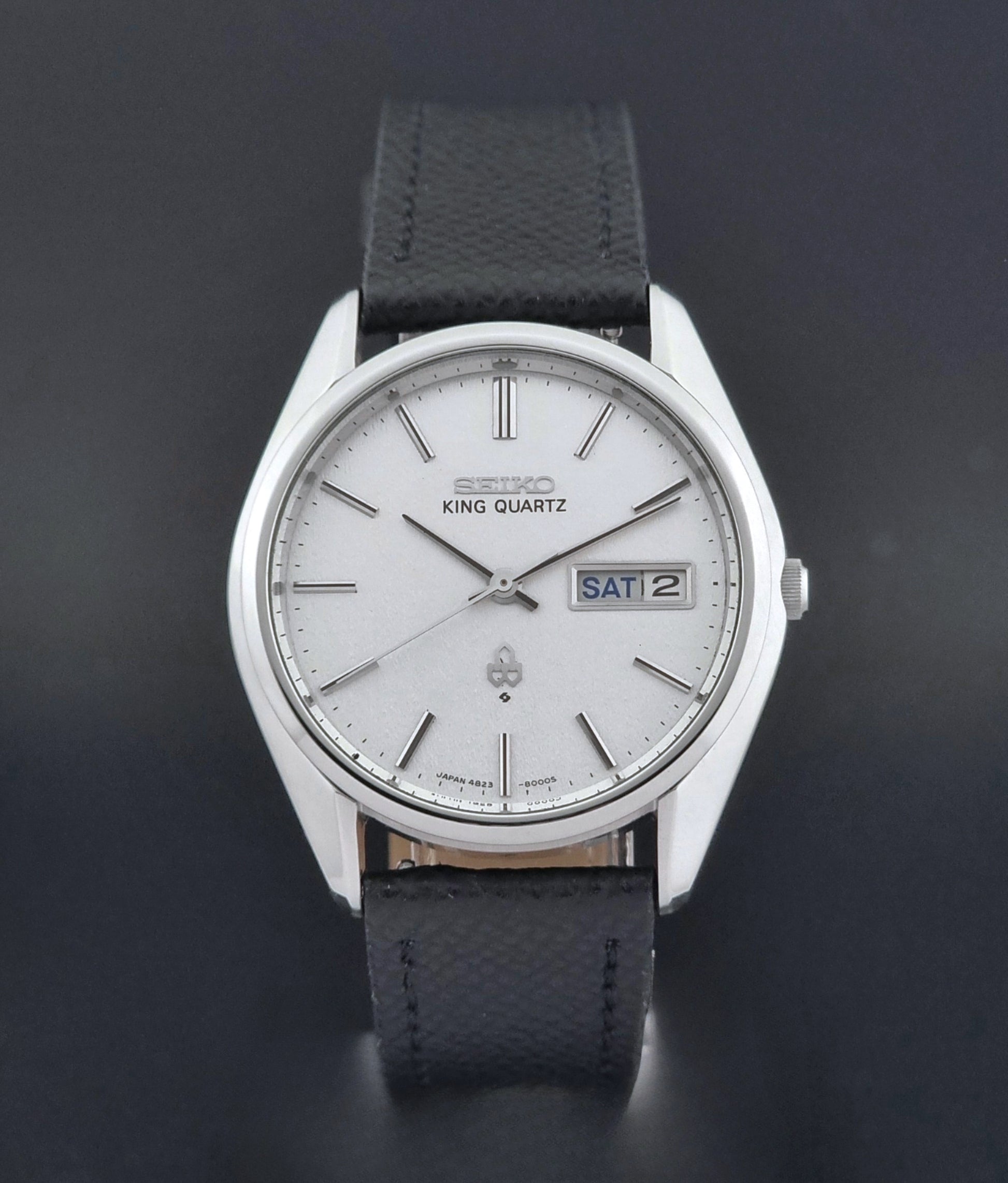 Vintage Seiko King Quartz watch 4823-8000  with black leather strap on a dark background close dial view