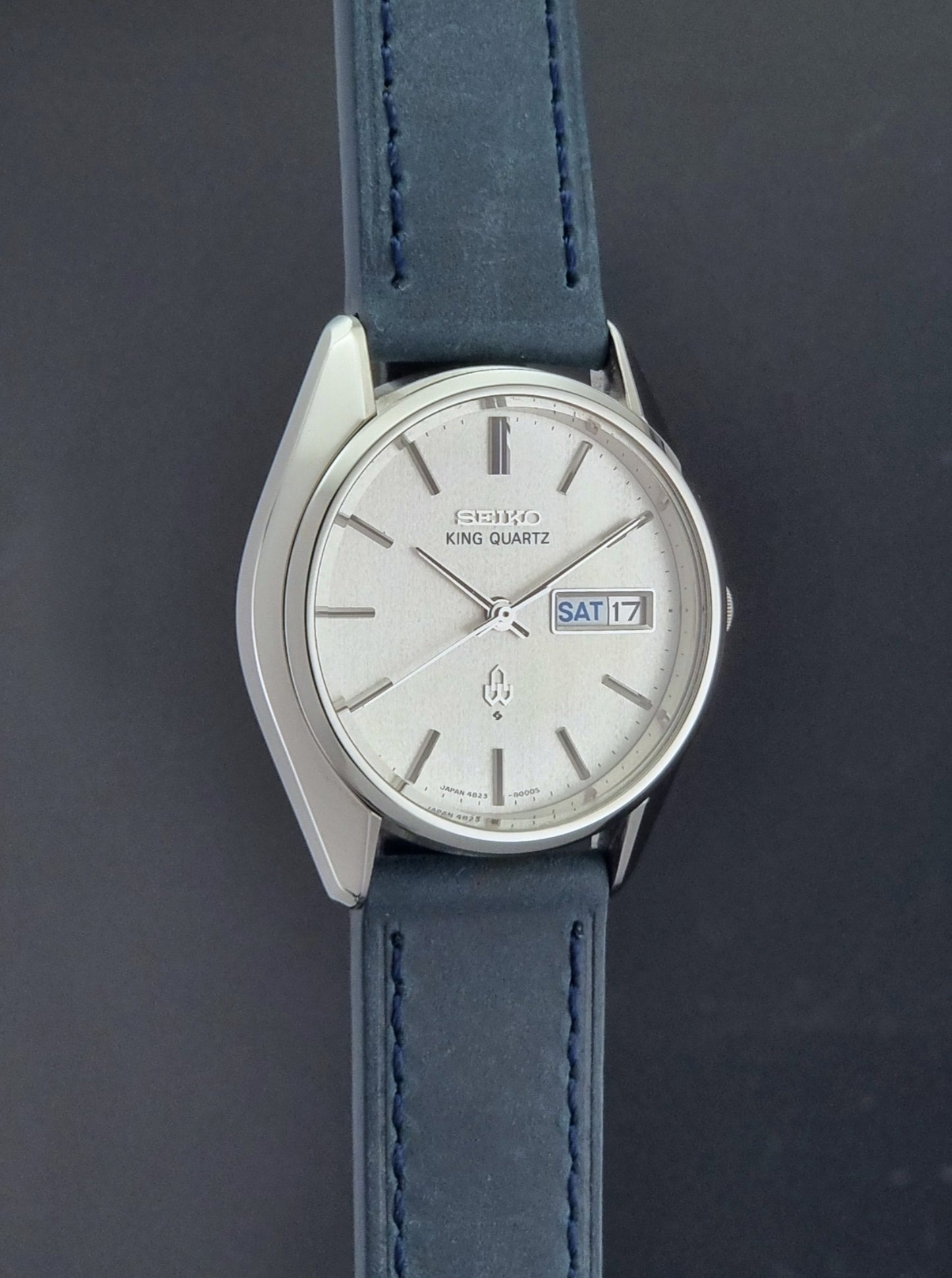 Vintage Seiko King Quartz 4823-8000-G with a blue leather strap on a dark background side profile view