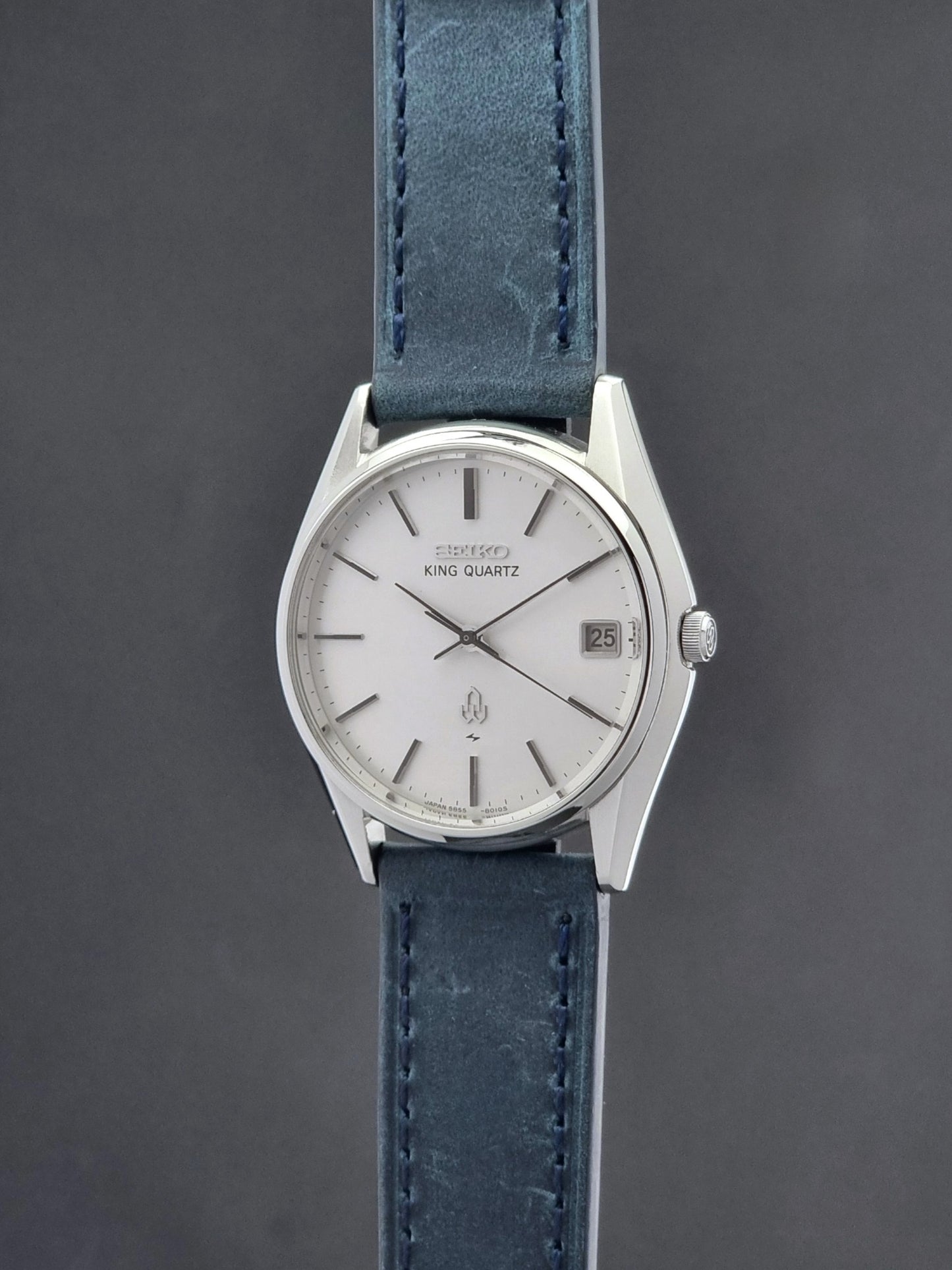 Vintage Seiko King Quartz watch 5855-8010 with blue leather strap on a gray background crown profile view