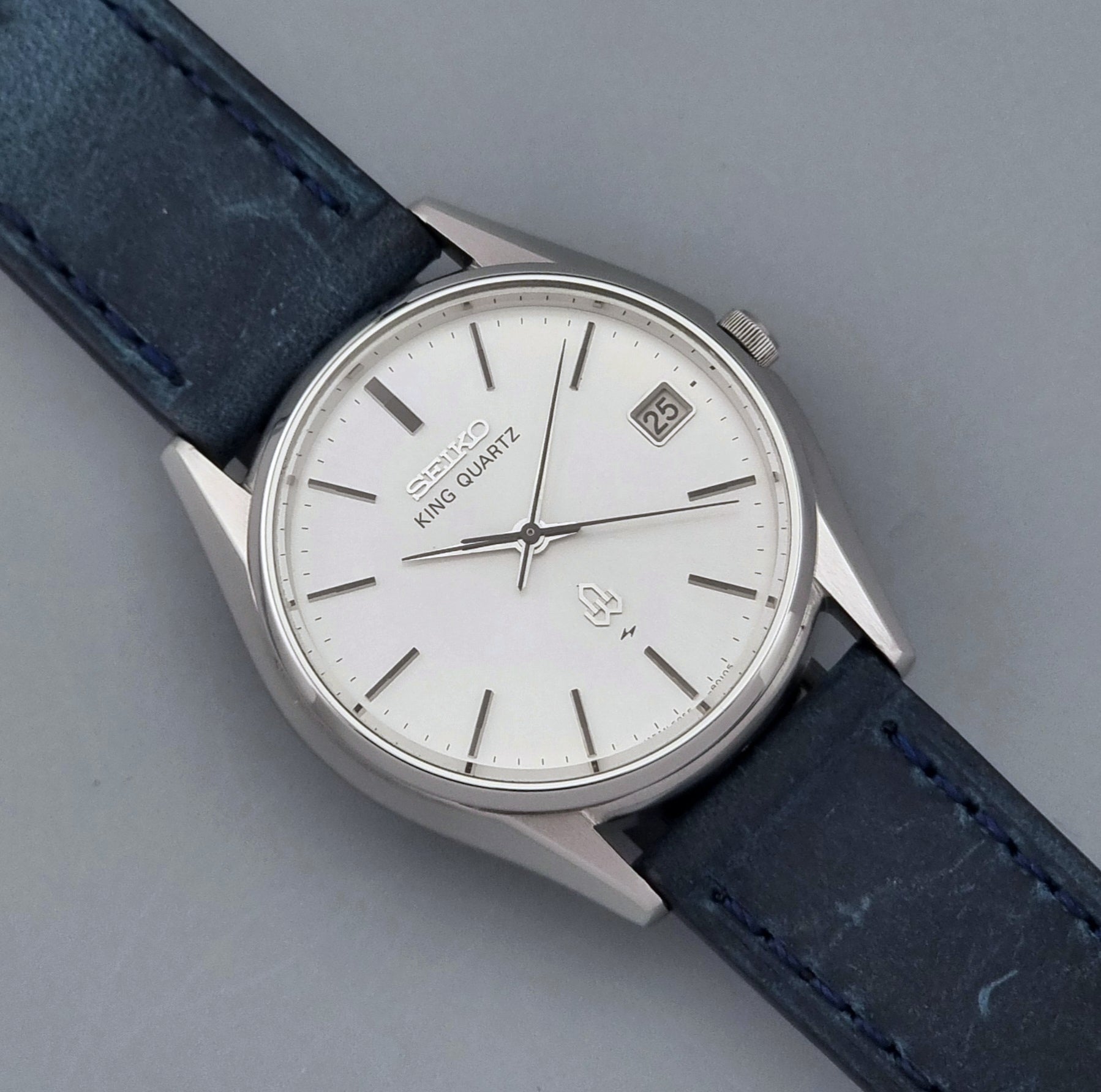 Vintage Seiko King Quartz watch 5855-8010 with blue leather strap on a gray background close up dial view
