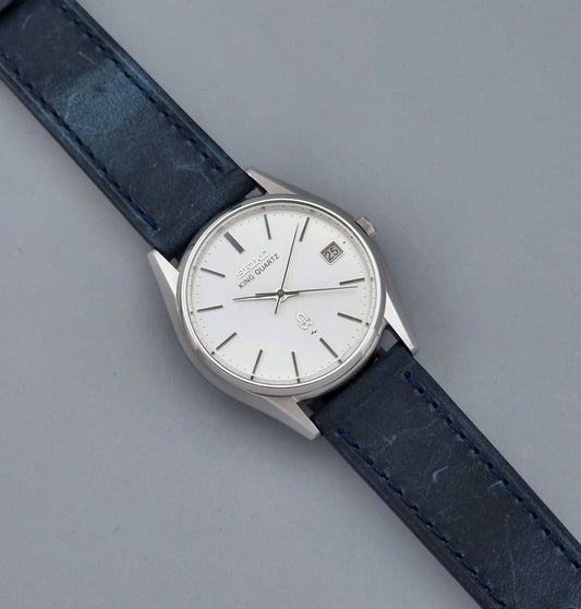 Vintage Seiko King Quartz watch 5855-8010 with blue leather strap on a gray background dial