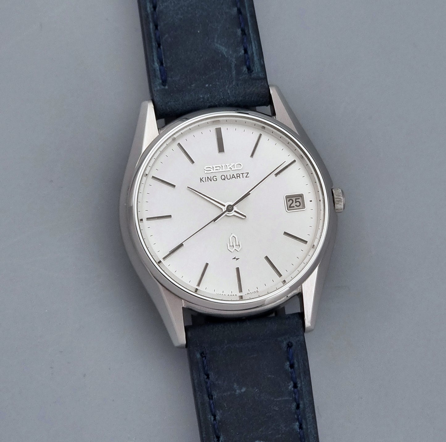 Vintage Seiko King Quartz watch 5855-8010 with blue leather strap on a gray background front view